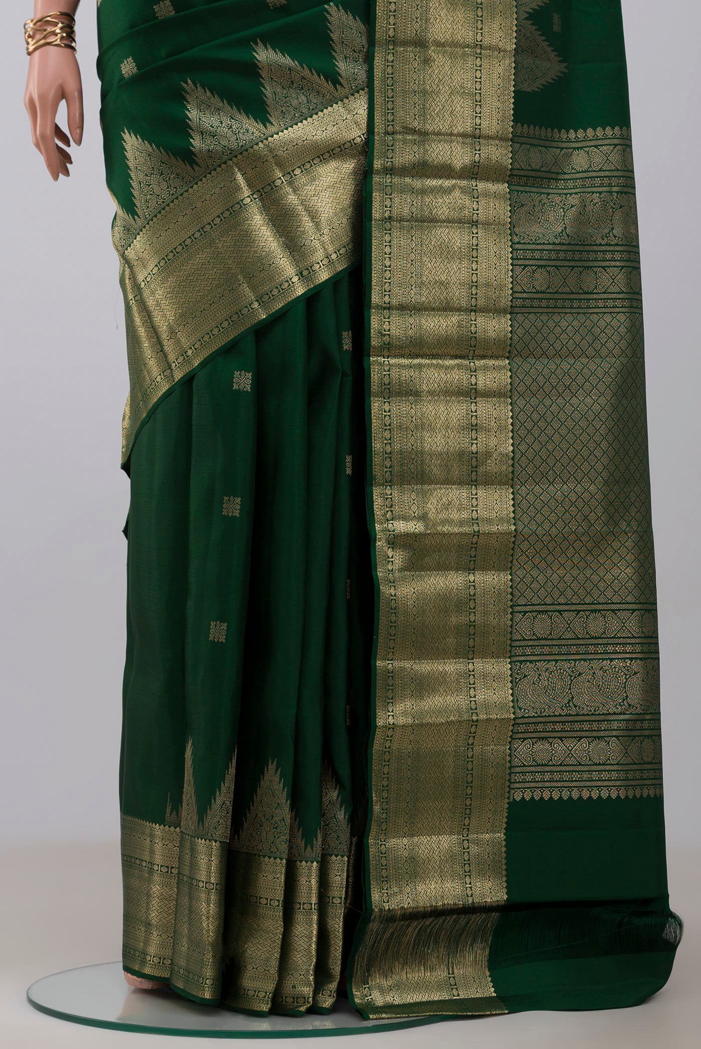 Pleats and pallu of Bottle Green Kanjivaram Silk Saree with Zari Butta on the body and Temple Border. 