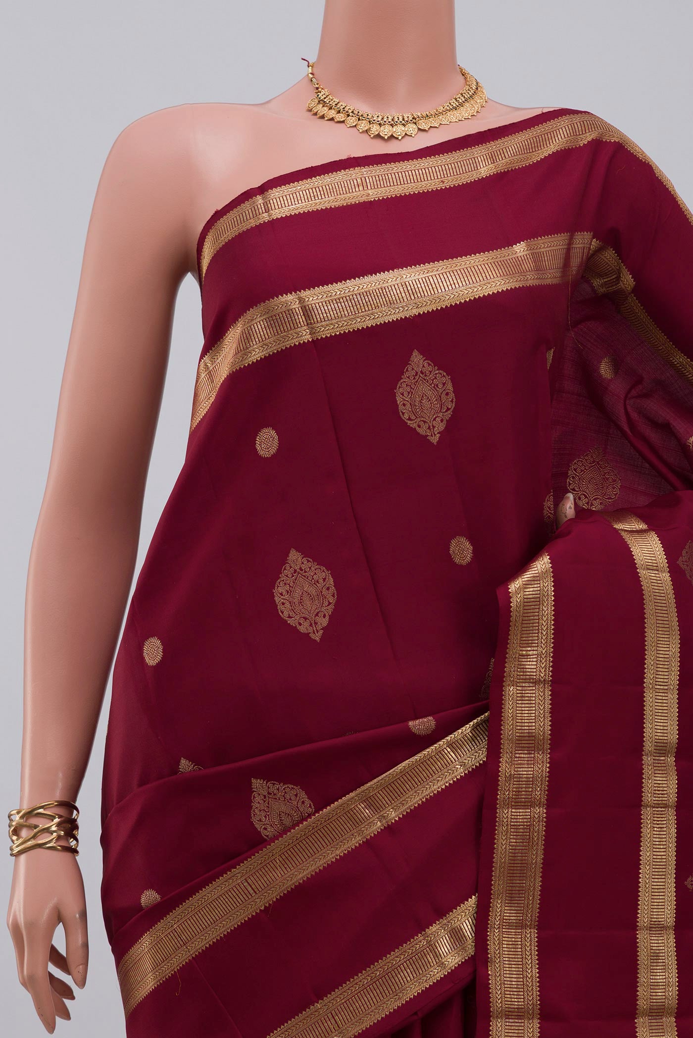 Border image of Maroon Kanjivaram Silk Saree with Zari Butta on the body and Zari Border. 