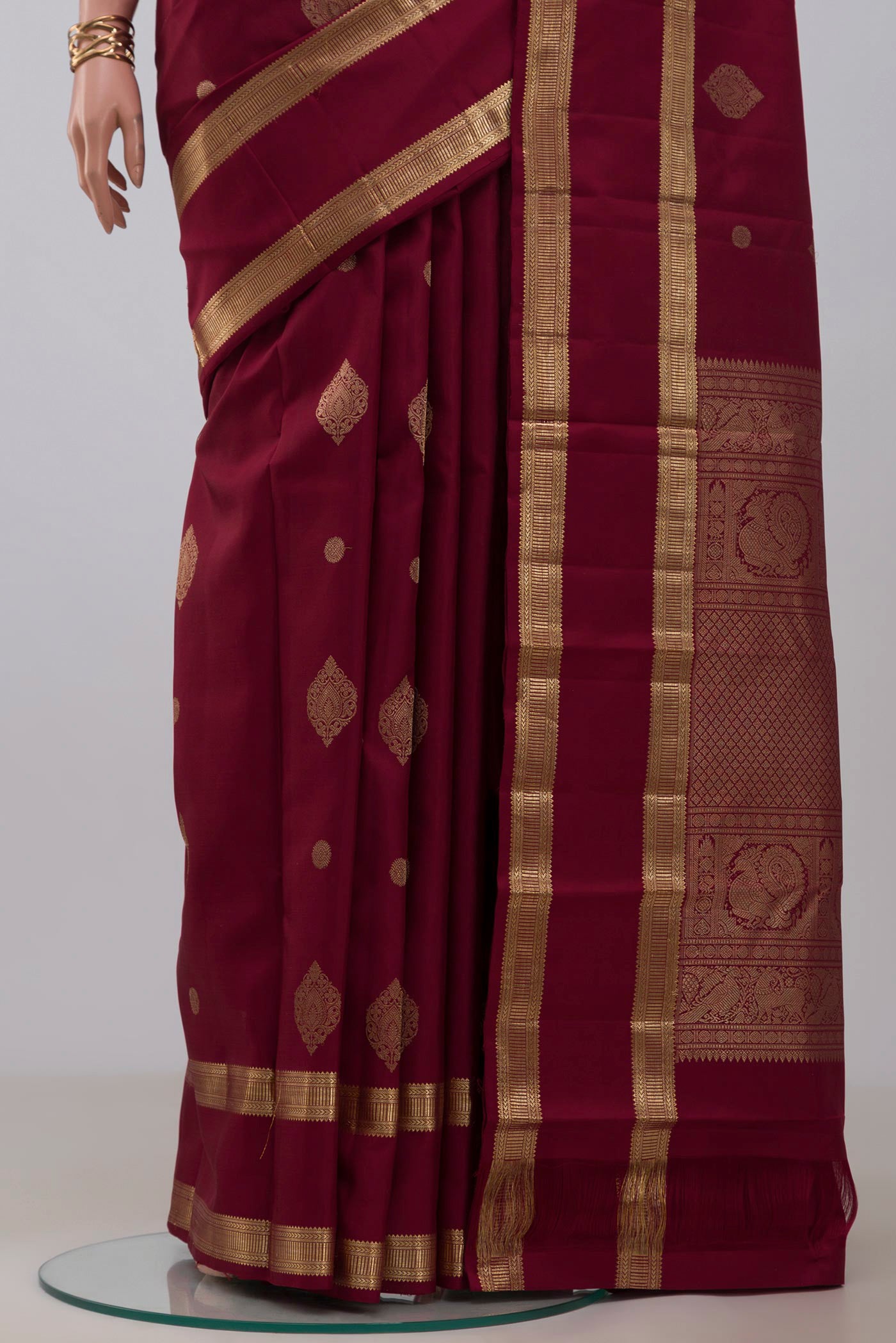 Pleats and pallu of Maroon Kanjivaram Silk Saree with Zari Butta on the body and Zari Border. 