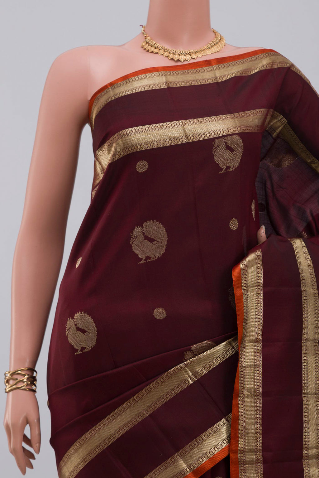 Border image of Maroon Kanjivaram Silk Saree with Zari Butta on the body and Zari Border. 