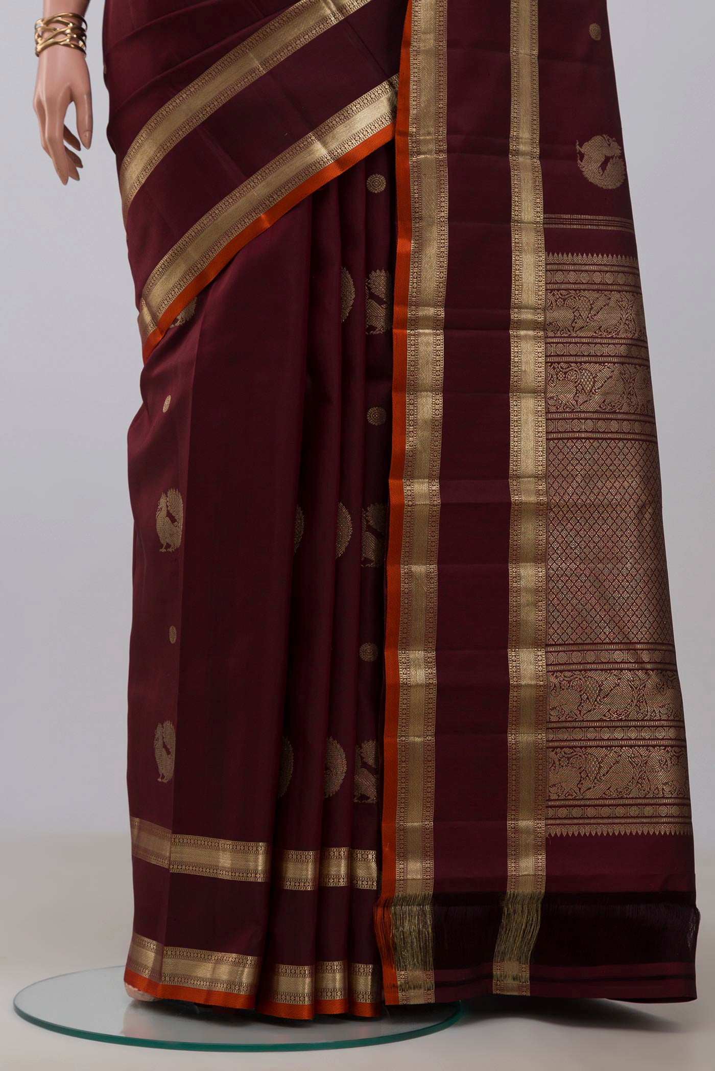 Pleats and pallu of Maroon Kanjivaram Silk Saree with Zari Butta on the body and Zari Border. 