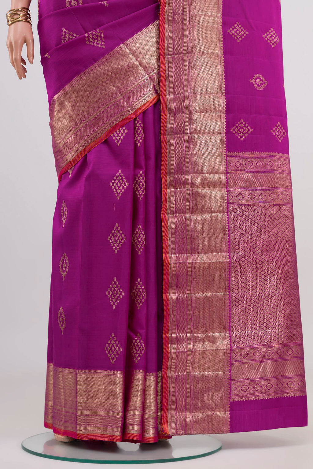 Pleats and pallu of Magenta Kanjivaram Silk Saree with Zari Butta on the body and Zari Border. 