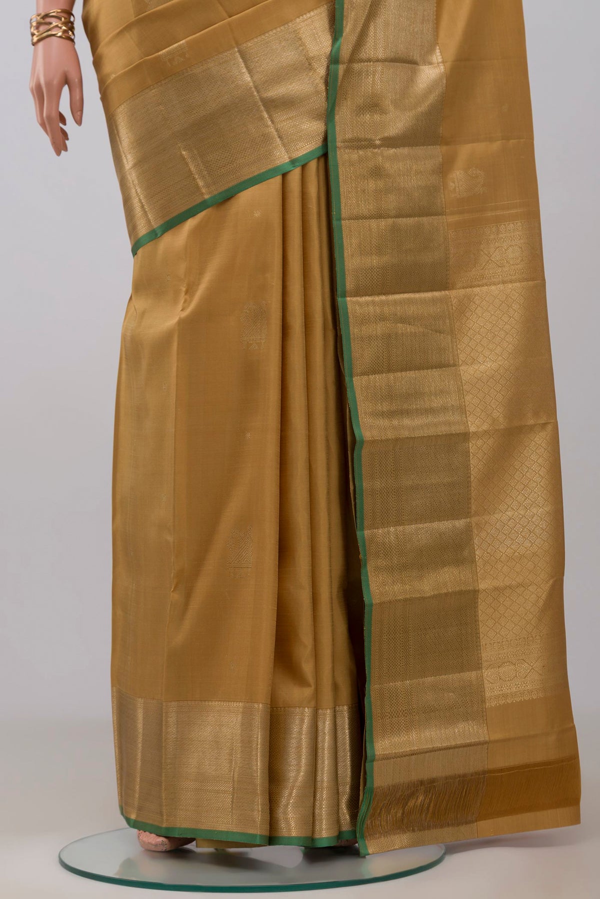 Pleats and pallu of Dark Beige Kanjivaram Silk Saree with Zari Butta on the body and Zari Border. 
