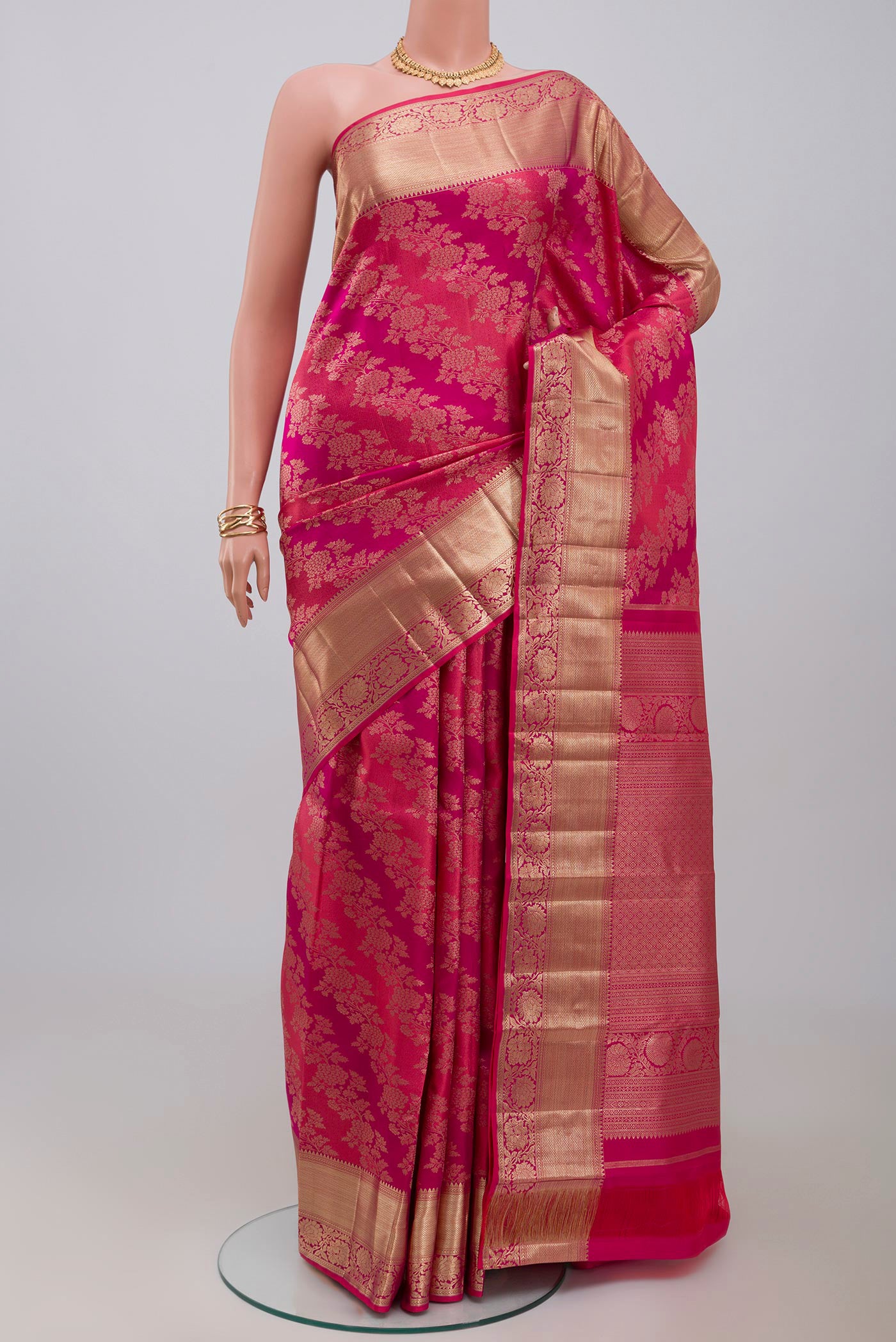 Pink Kanjivaram Silk Saree with Zari Brocade on the body and Zari Border.  displayed on a mannequin