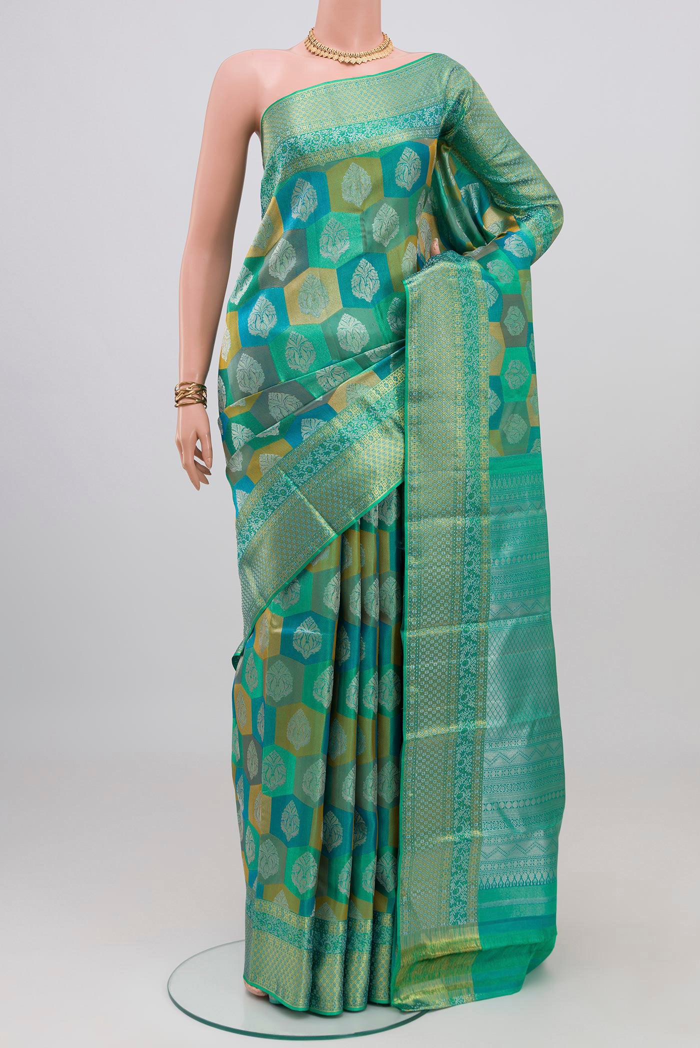 Turquoise Kanjivaram Silk Saree with Zari Brocade on the body and Zari Border.  displayed on a mannequin
