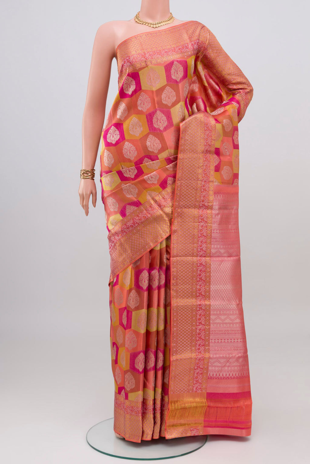 Coral Kanjivaram Silk Saree with Zari Brocade on the body and Zari Border.  displayed on a mannequin