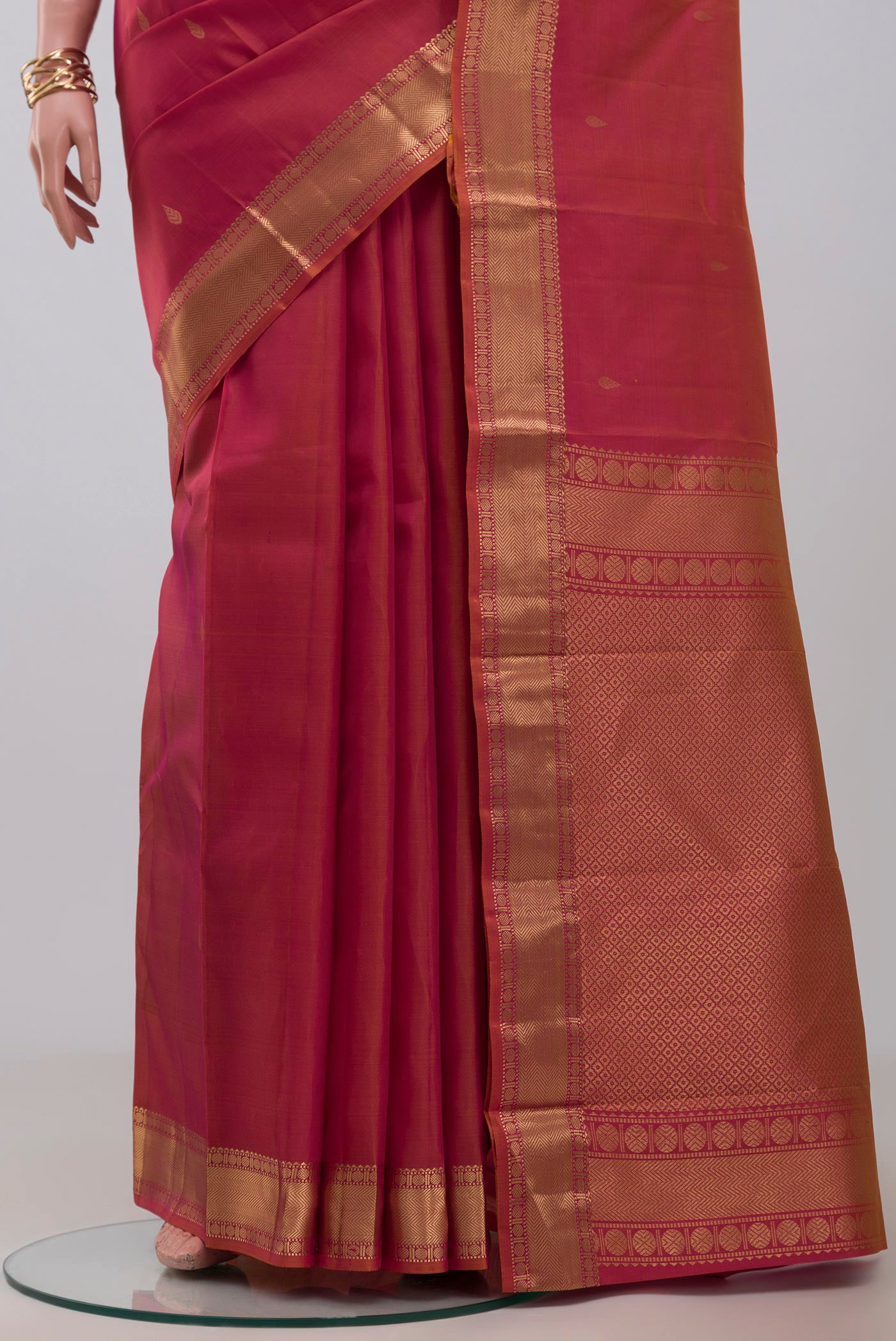 Pleats and pallu of Orange Kanchipuram Silk Saree with Zari Butta on the body and Zari Border. 