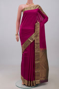 Maroon Kanjivaram Silk Saree with Plain Body and Zari Border.  displayed on a mannequin
