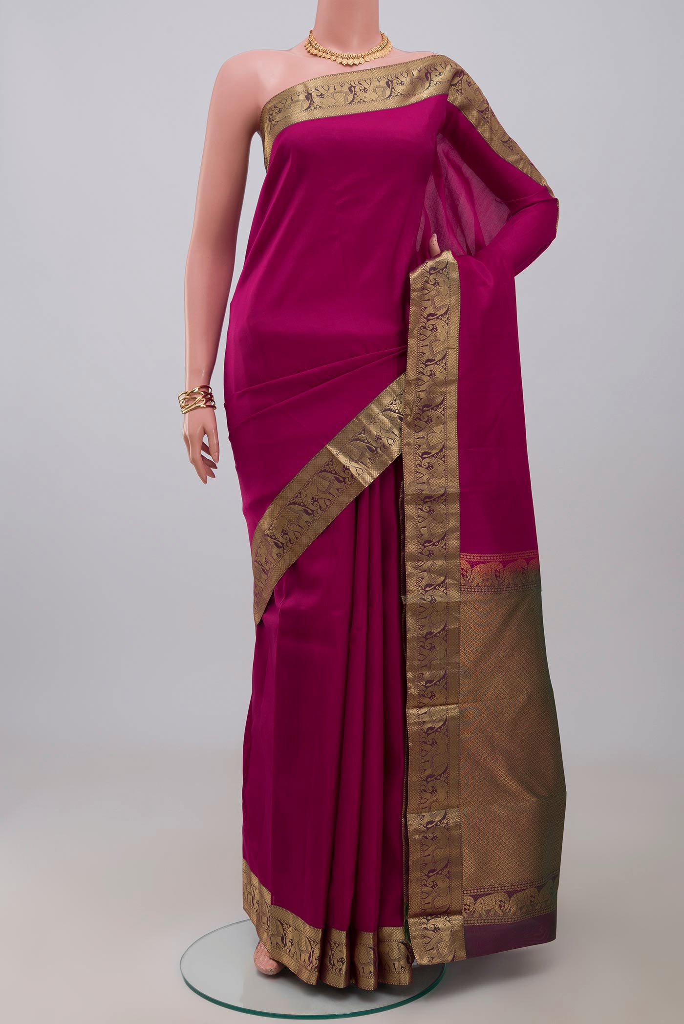 Maroon Kanjivaram Silk Saree with Plain Body and Zari Border.  displayed on a mannequin