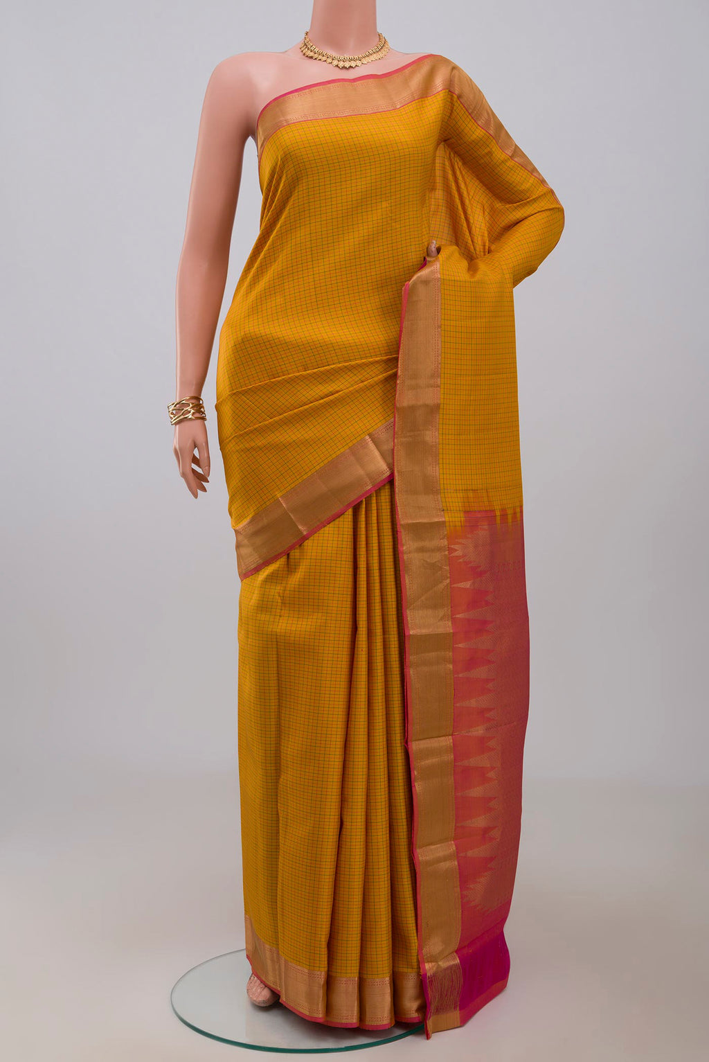Yellow Kanchipuram Silk Saree with Checked design on the body and Zari Border.  displayed on a mannequin
