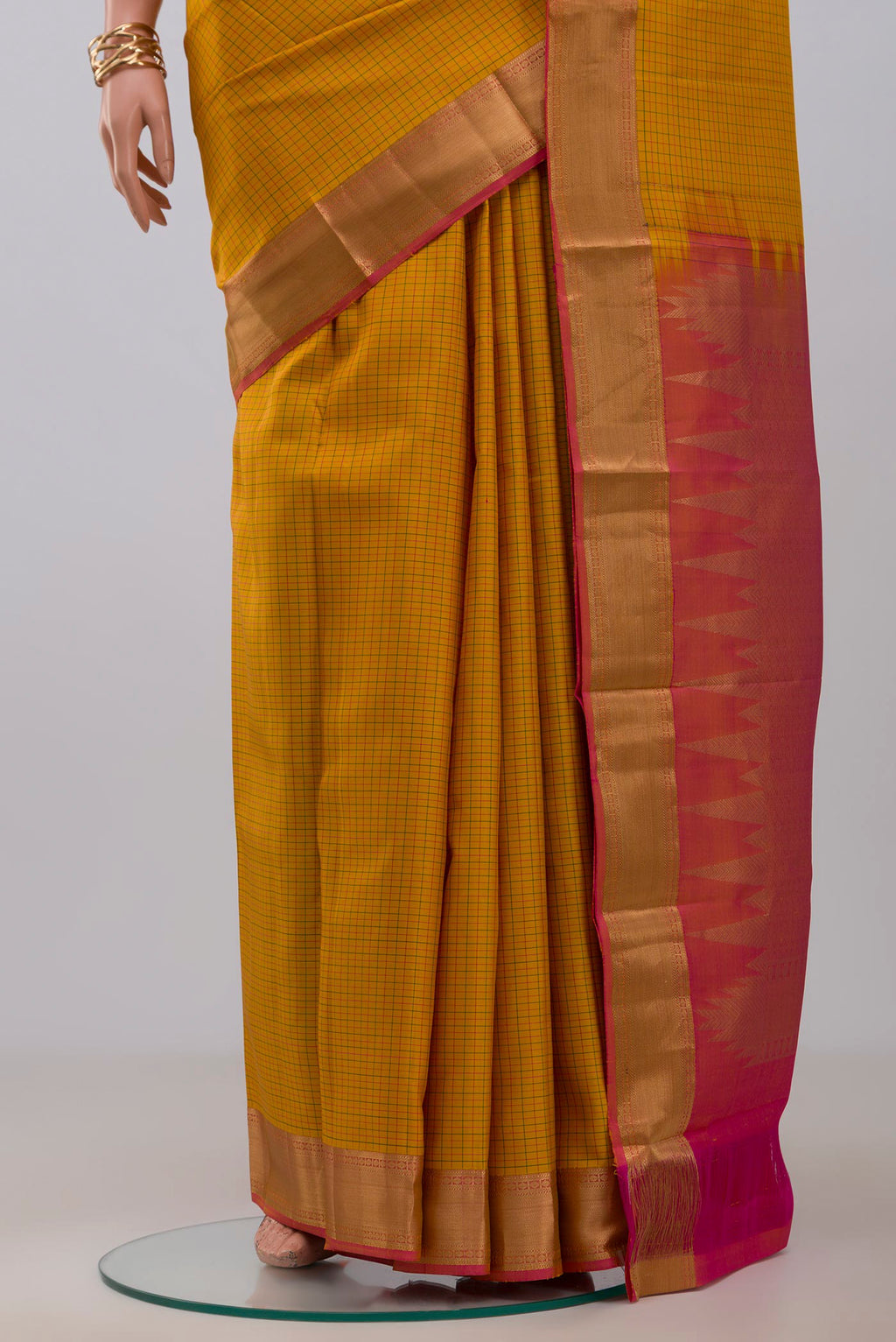 Pleats and pallu of Yellow Kanchipuram Silk Saree with Checked design on the body and Zari Border. 