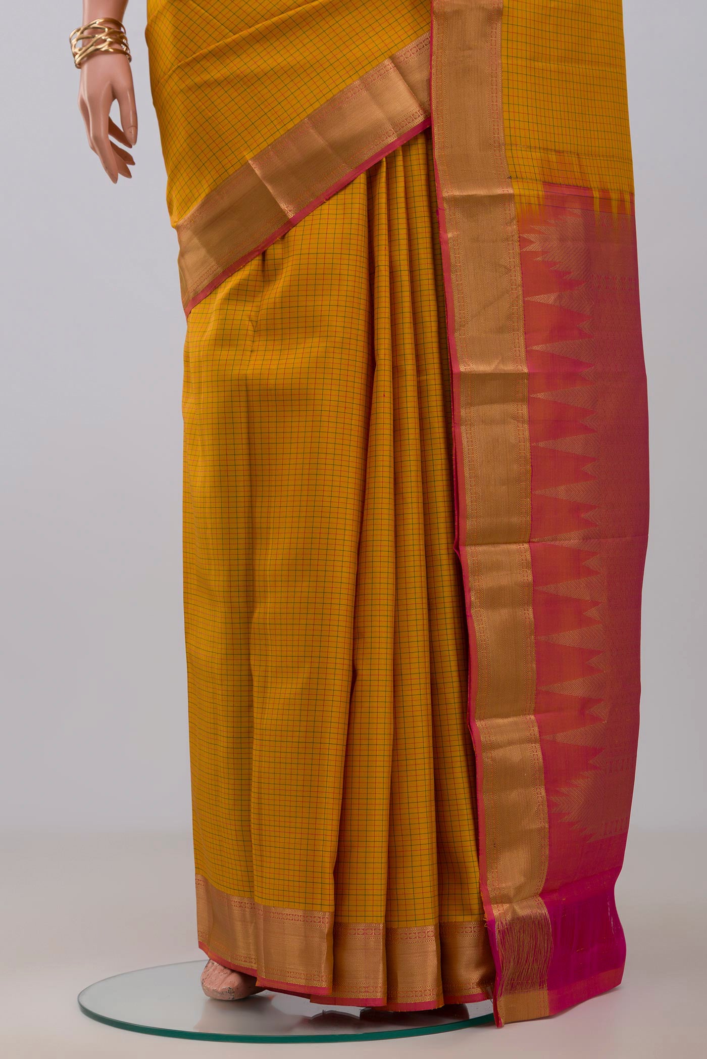 Pleats and pallu of Yellow Kanchipuram Silk Saree with Checked design on the body and Zari Border. 