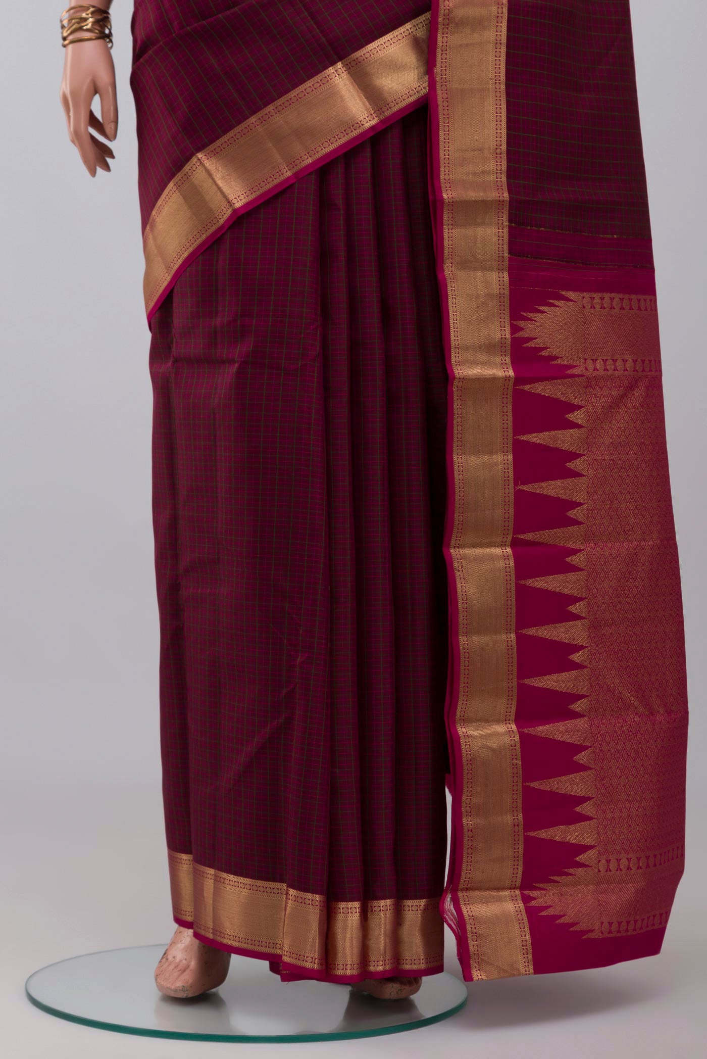 Pleats and pallu of Maroon Kanchipuram Silk Saree with Checked design on the body and Zari Border. 