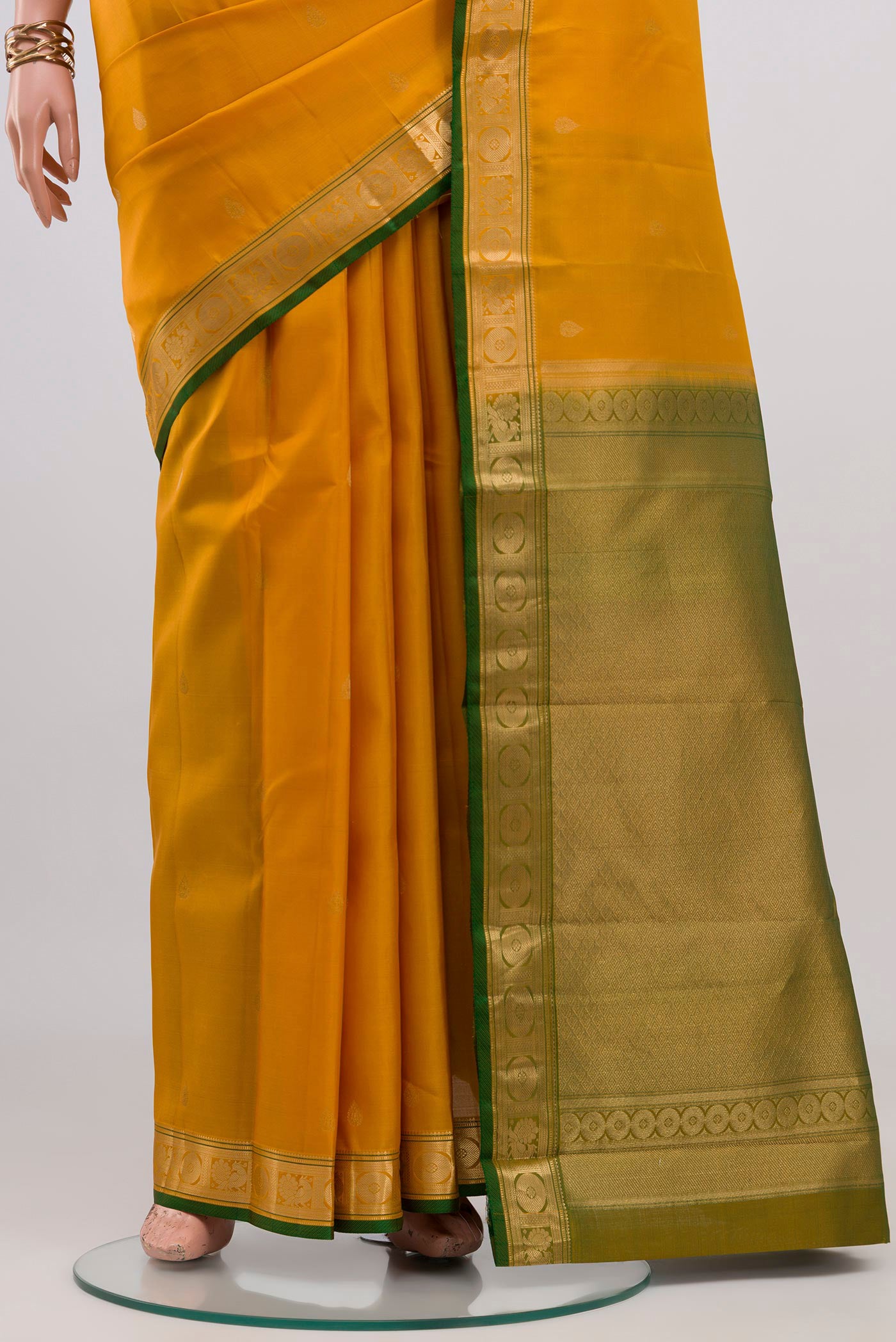 Pleats and pallu of Yellow Kanchipuram Silk Saree with Zari Butta on the body and Zari Border. 