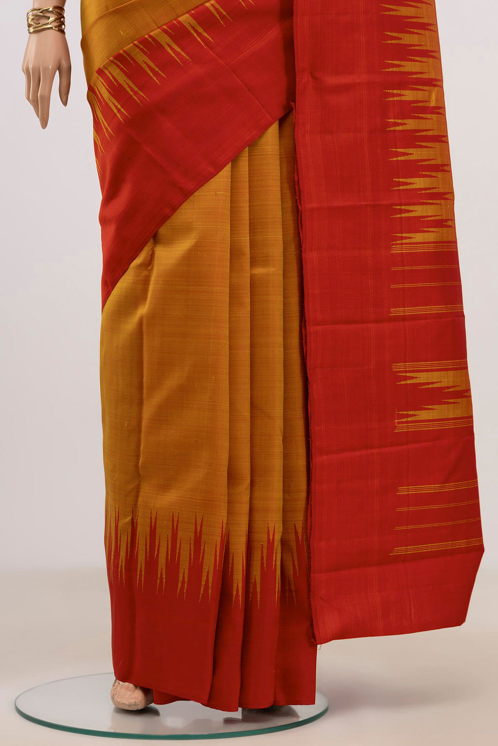 Pleats and pallu of Mustard Kanjivaram Silk Saree with Plain Body and Temple Border. 