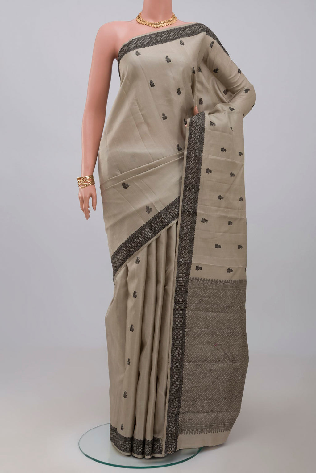 Grey Kanchipuram Saree with Thread Butta on the body and Thread Border.  displayed on a mannequin