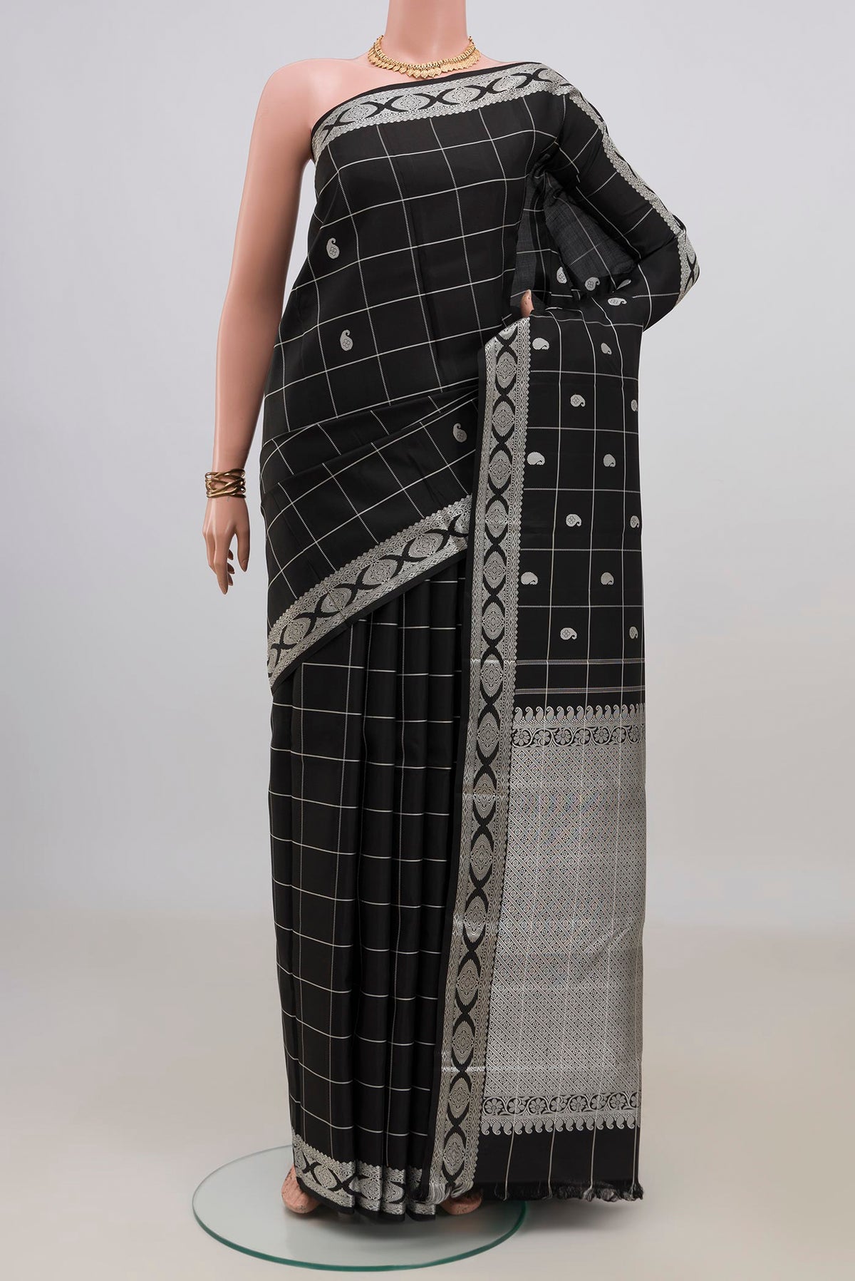 Pure Silk Black Kanjivaram Saree with Checked design on the body and Thread Border.  displayed on a mannequin