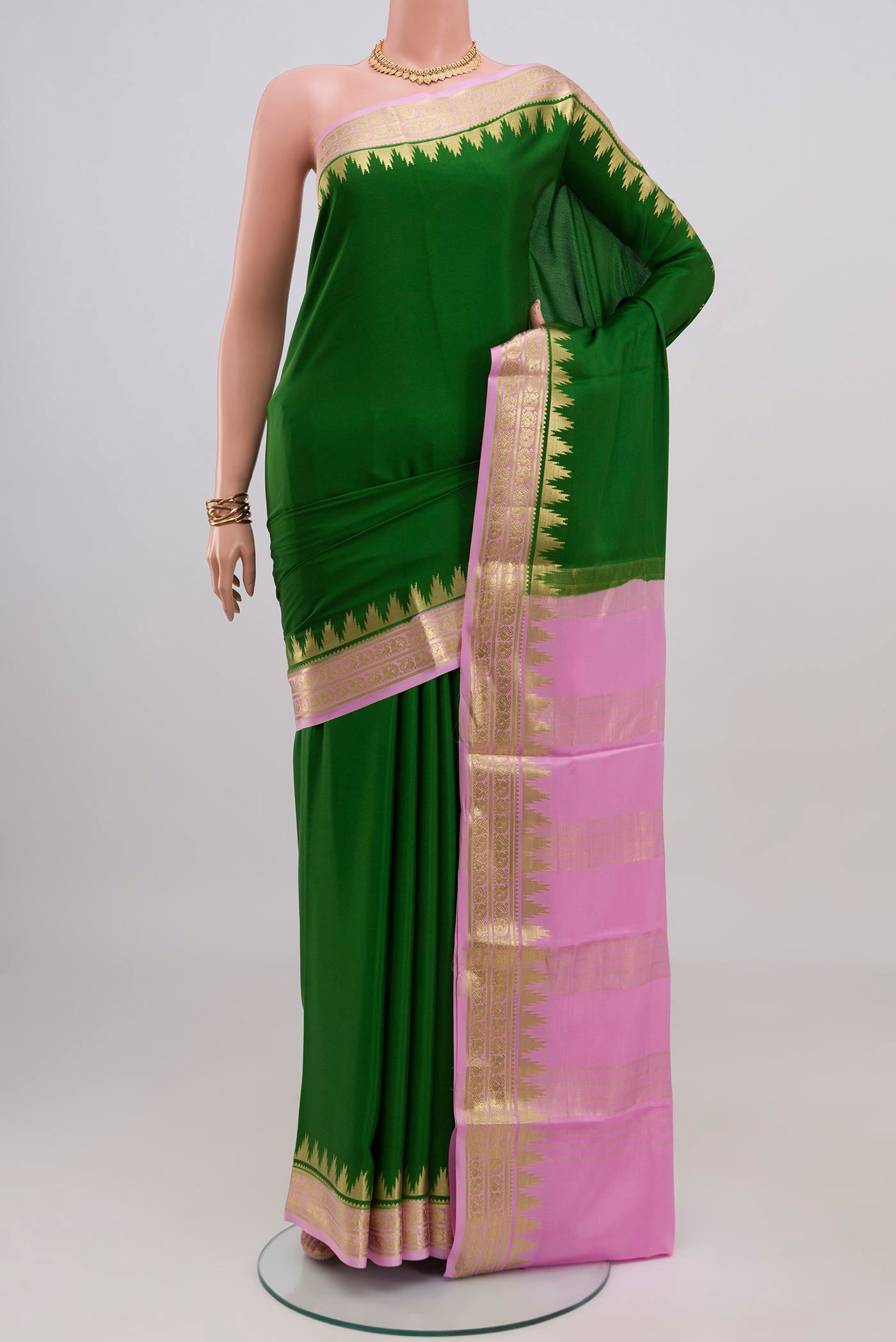 Green Mysore Crepe Saree with Plain Body and Zari Border.  displayed on a mannequin