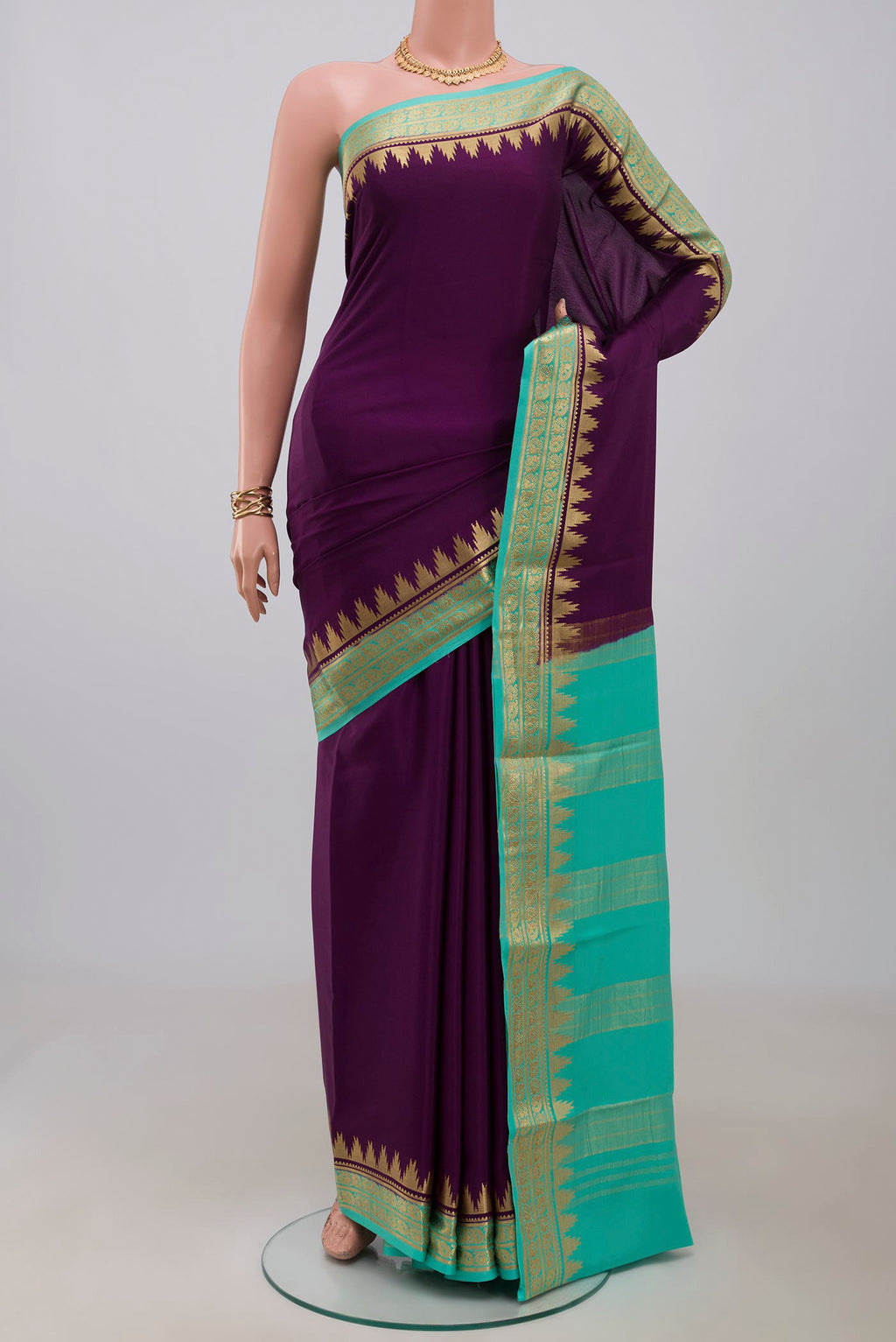 Purple Crepe Saree with Plain Body and Zari Border.  displayed on a mannequin