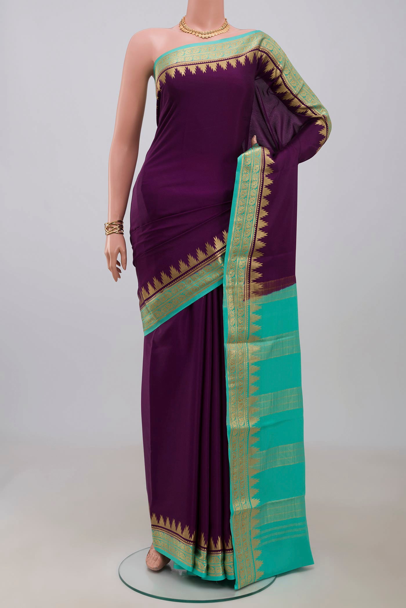 Purple Crepe Saree with Plain Body and Zari Border.  displayed on a mannequin