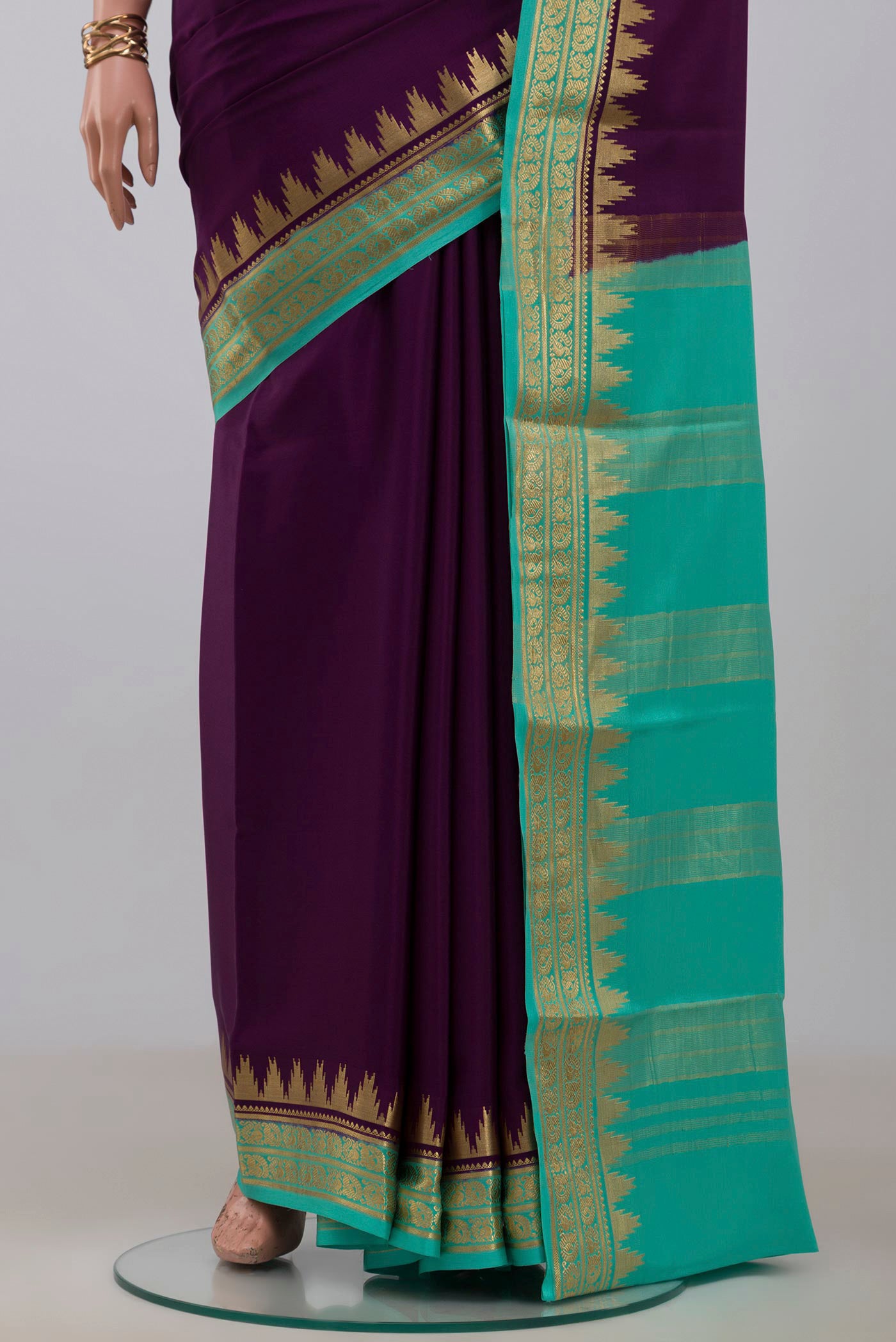 Pleats and pallu of Purple Crepe Saree with Plain Body and Zari Border. 