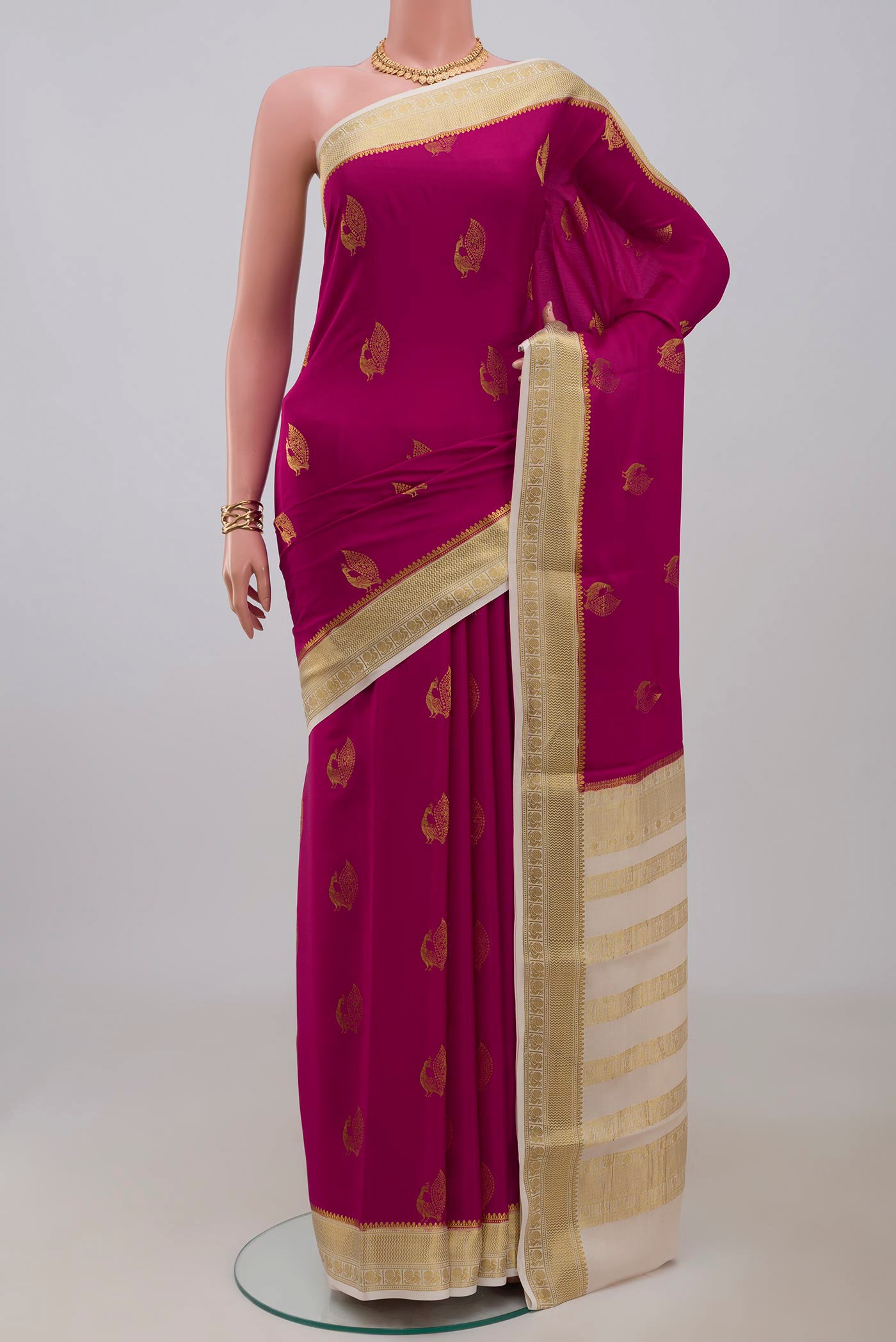 Rani Pink Mysore Crepe Saree with Zari Butta on the body and Zari Border.  displayed on a mannequin