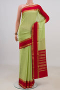 Light Green Mysore Crepe Saree with Checked design on the body and Fancy Border.  displayed on a mannequin