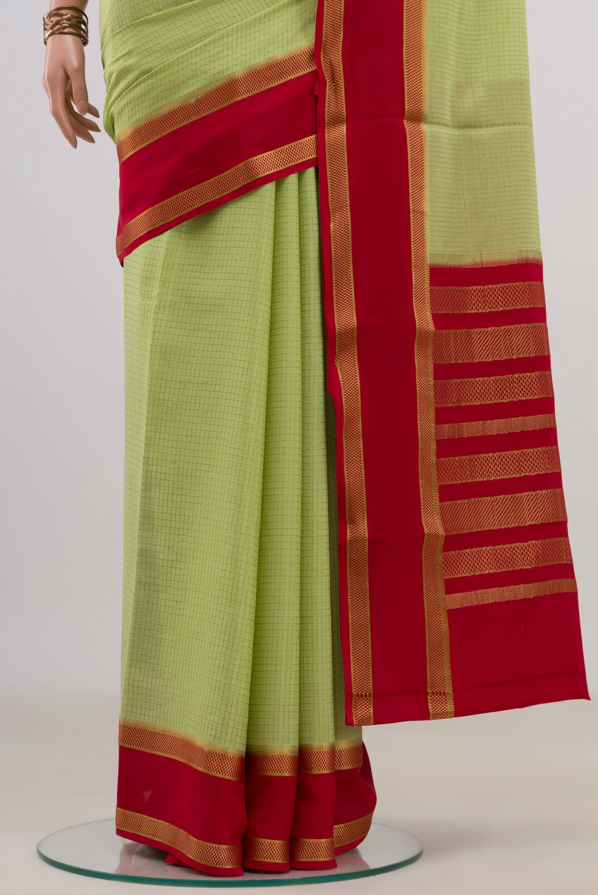 Pleats and pallu of Light Green Mysore Crepe Saree with Checked design on the body and Fancy Border. 