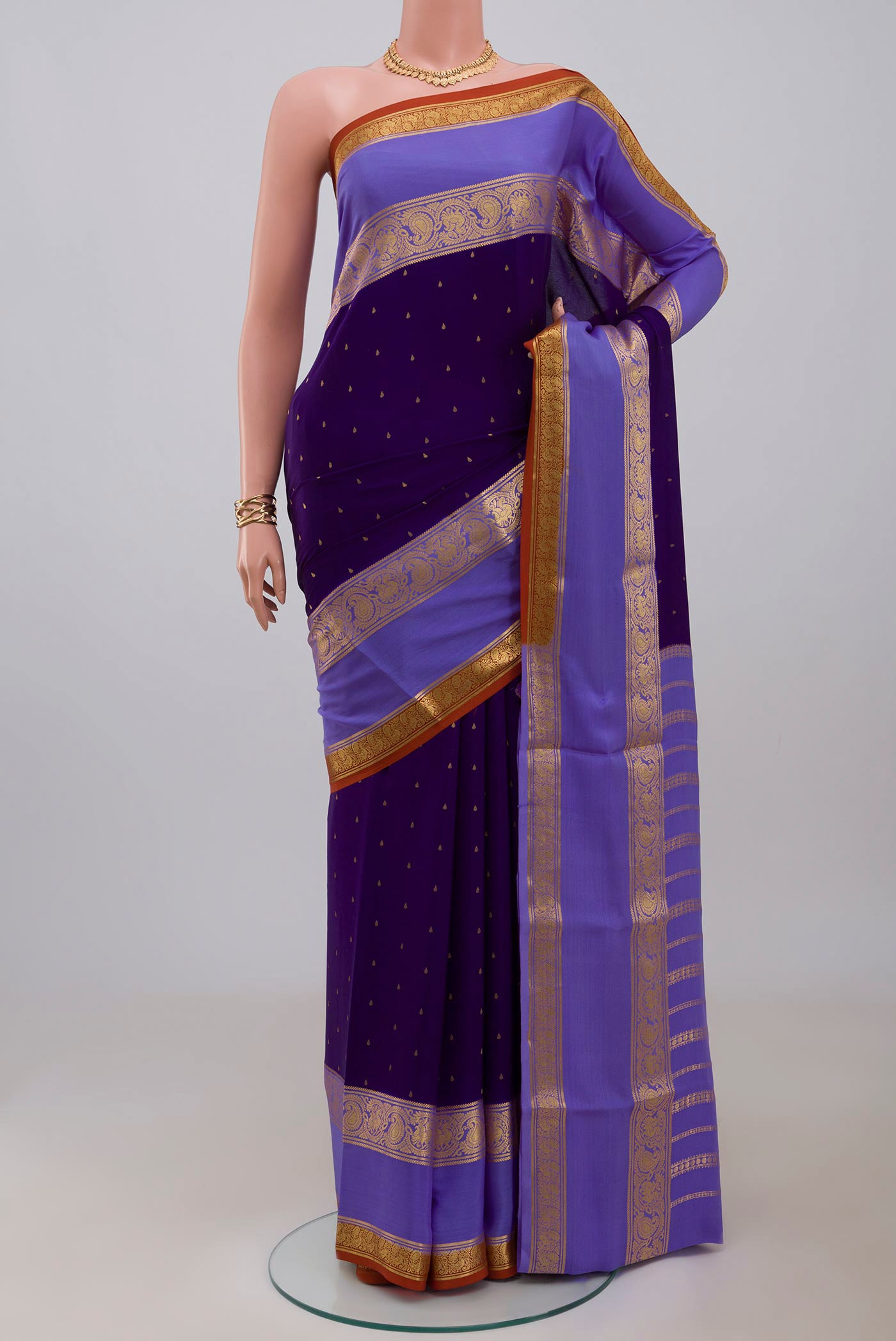 Navy Blue Mysore Crepe Saree with Zari Butta on the body and Zari Border.  displayed on a mannequin