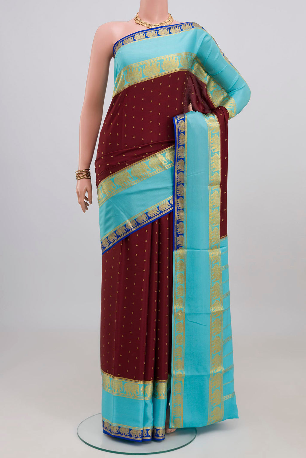Maroon Mysore Crepe Saree with Zari Butta on the body and Zari Border.  displayed on a mannequin