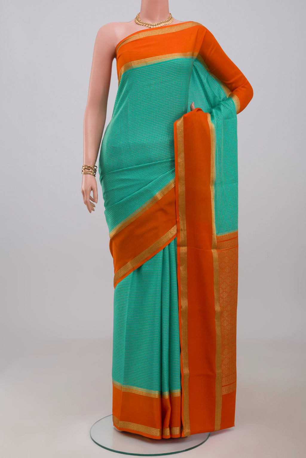 Sea Green Mysore Crepe Saree with Checked design on the body and Zari Border.  displayed on a mannequin