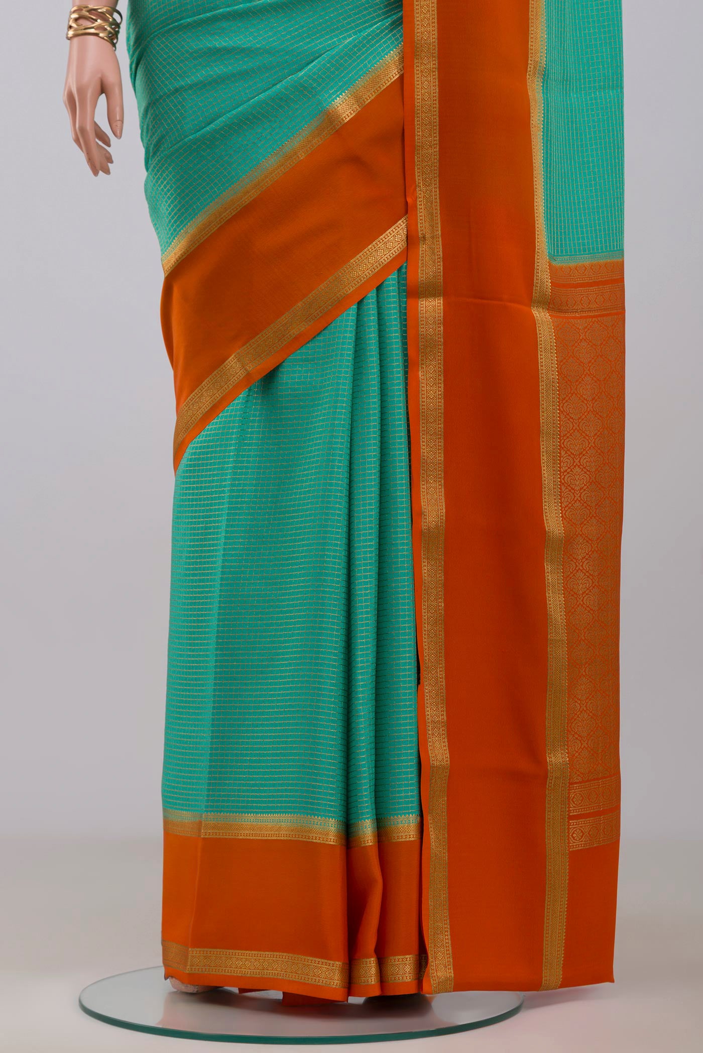 Pleats and pallu of Sea Green Mysore Crepe Saree with Checked design on the body and Zari Border. 