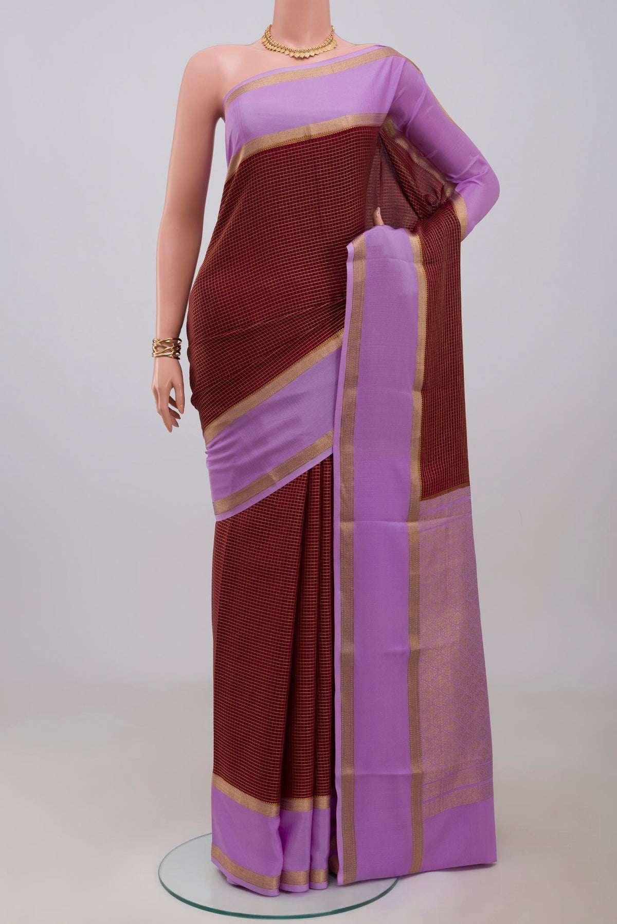Maroon Mysore Crepe Saree with Checked design on the body and Zari Border.  displayed on a mannequin