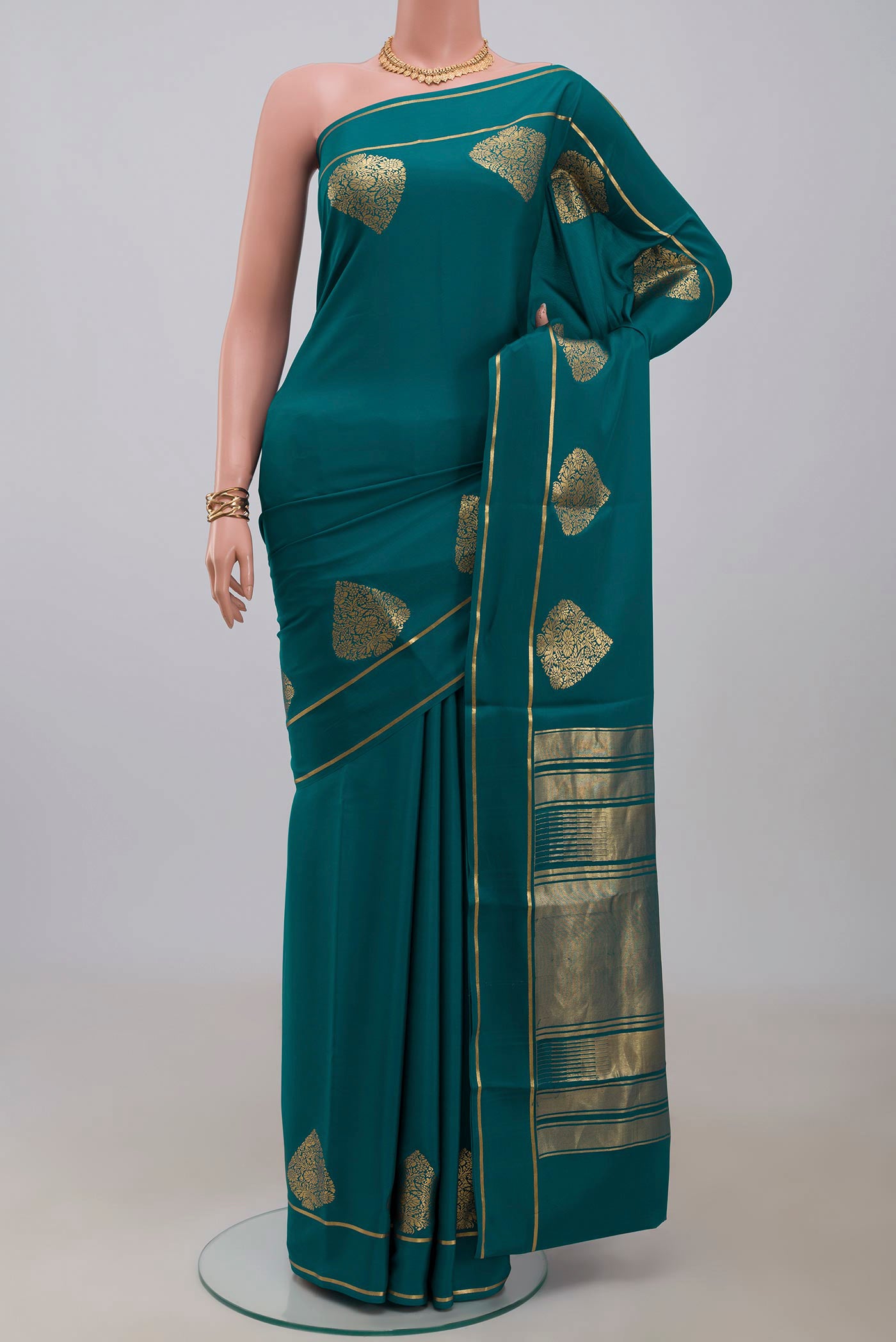 Blue Crepe Saree with Plain Body and Thin Zari Line.  displayed on a mannequin