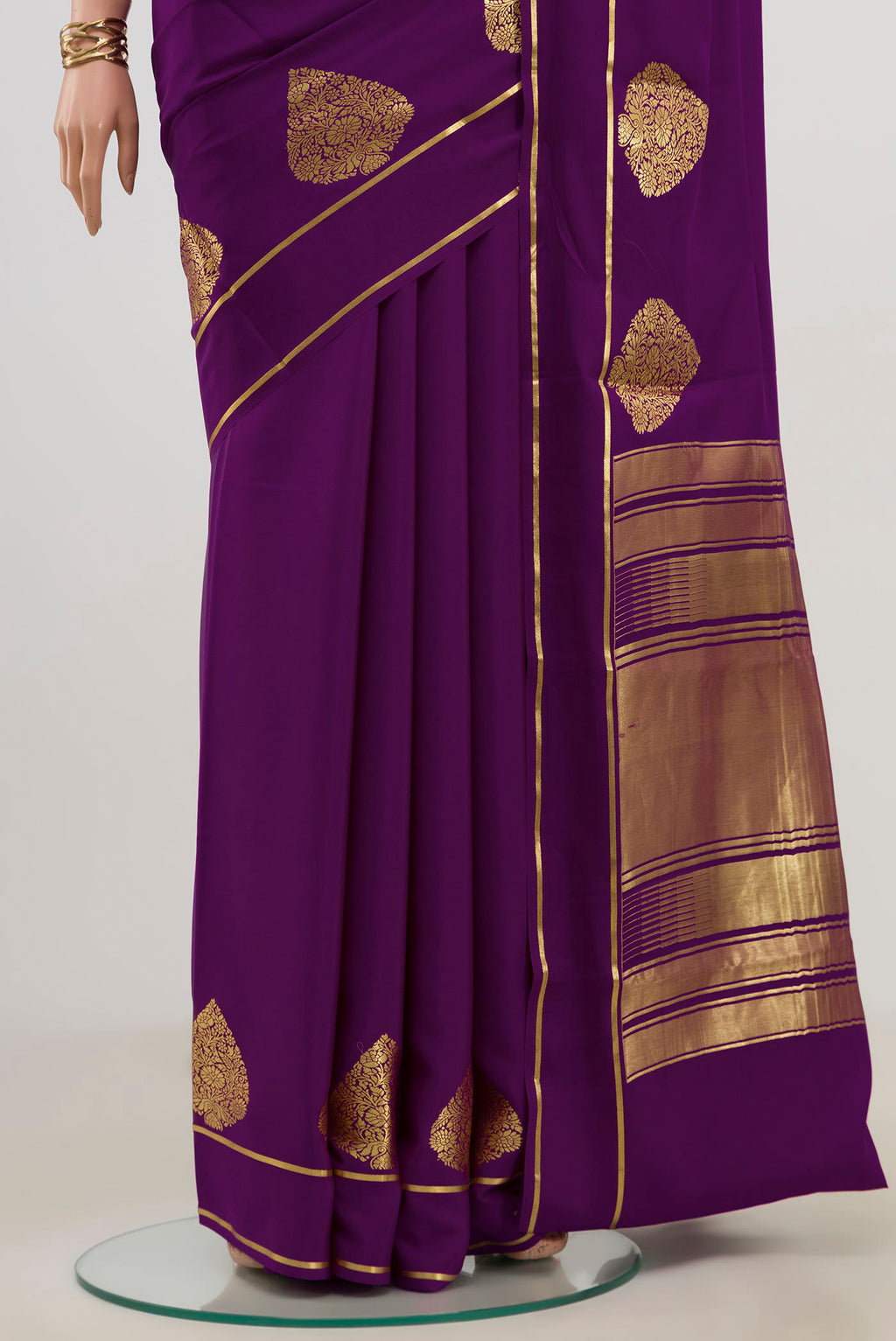 Pleats and pallu of Purple Crepe Saree with Plain Body and Thin Zari Line. 
