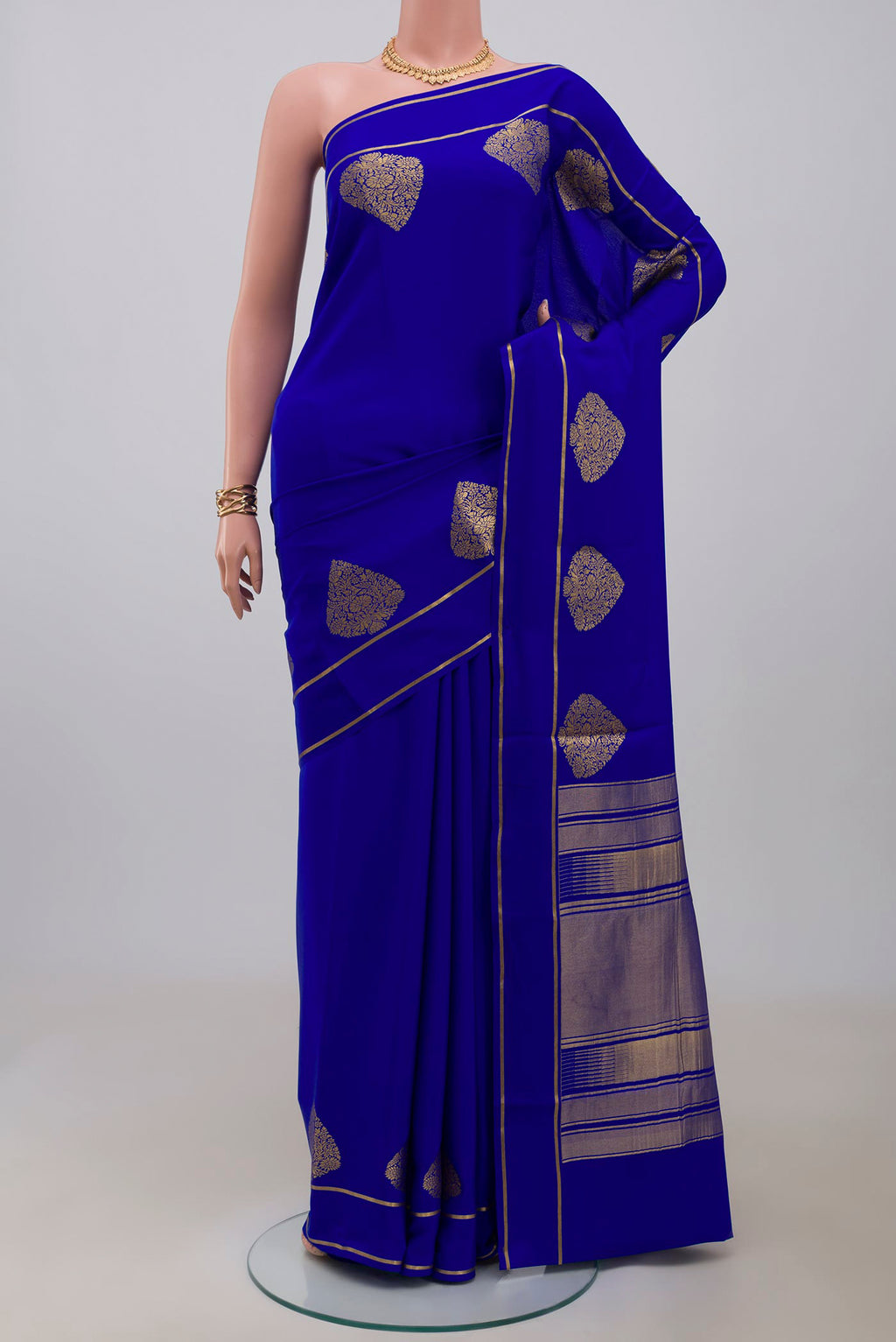 Blue Crepe Saree with Plain Body and Thin Zari Line.  displayed on a mannequin