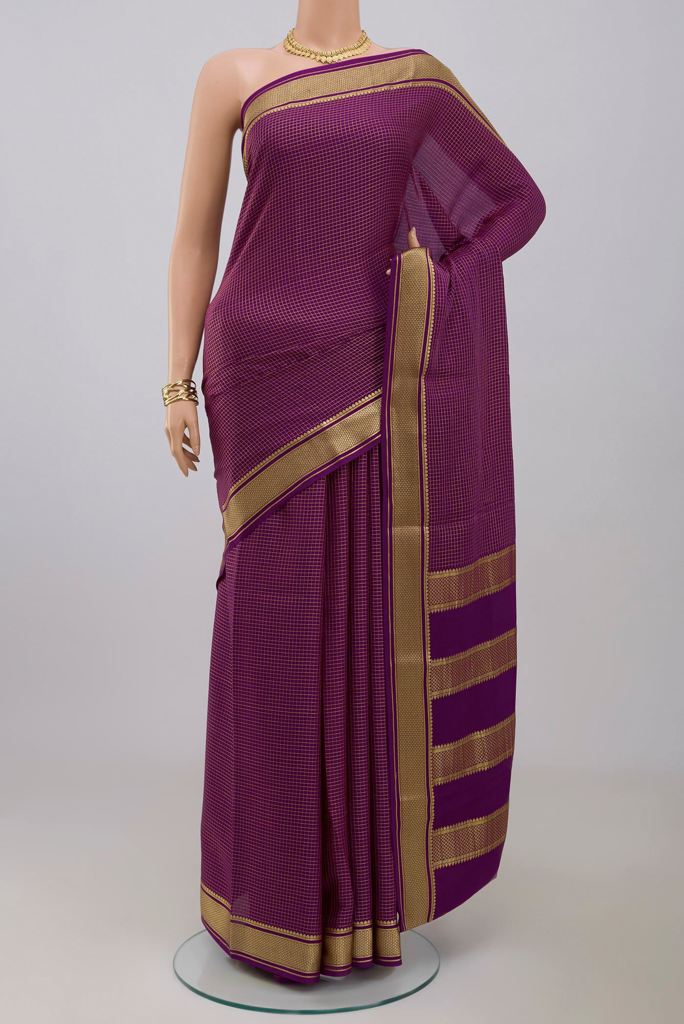 Purple Crepe Saree with Checked design on the body and Zari Border.  displayed on a mannequin