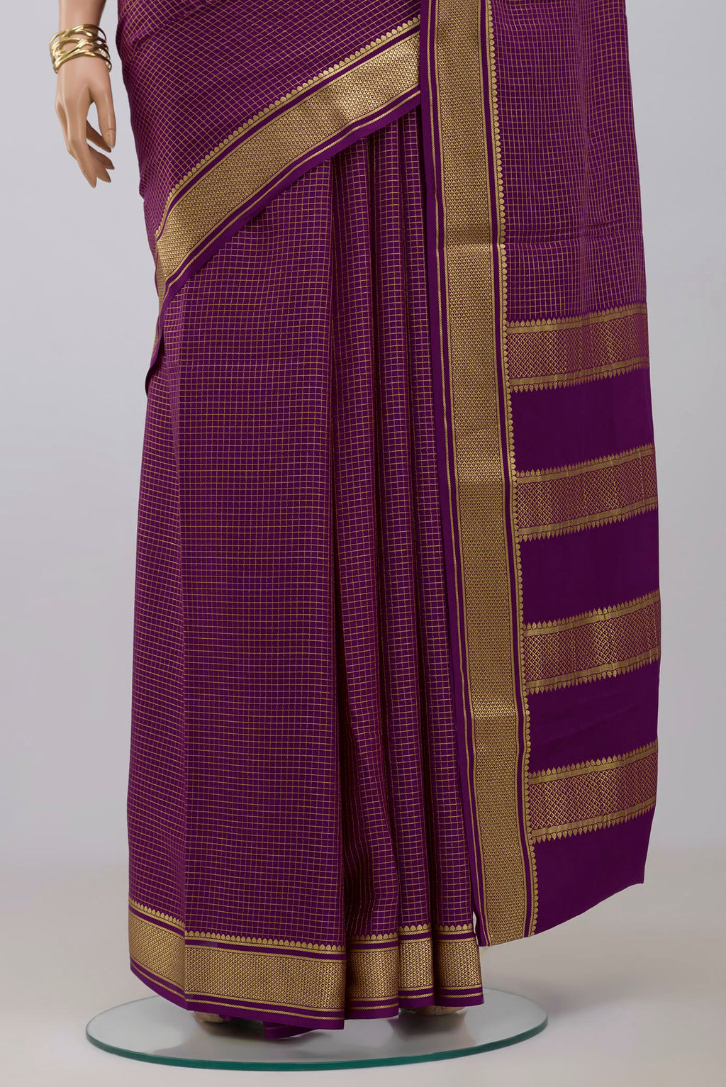 Pleats and pallu of Purple Crepe Saree with Checked design on the body and Zari Border. 