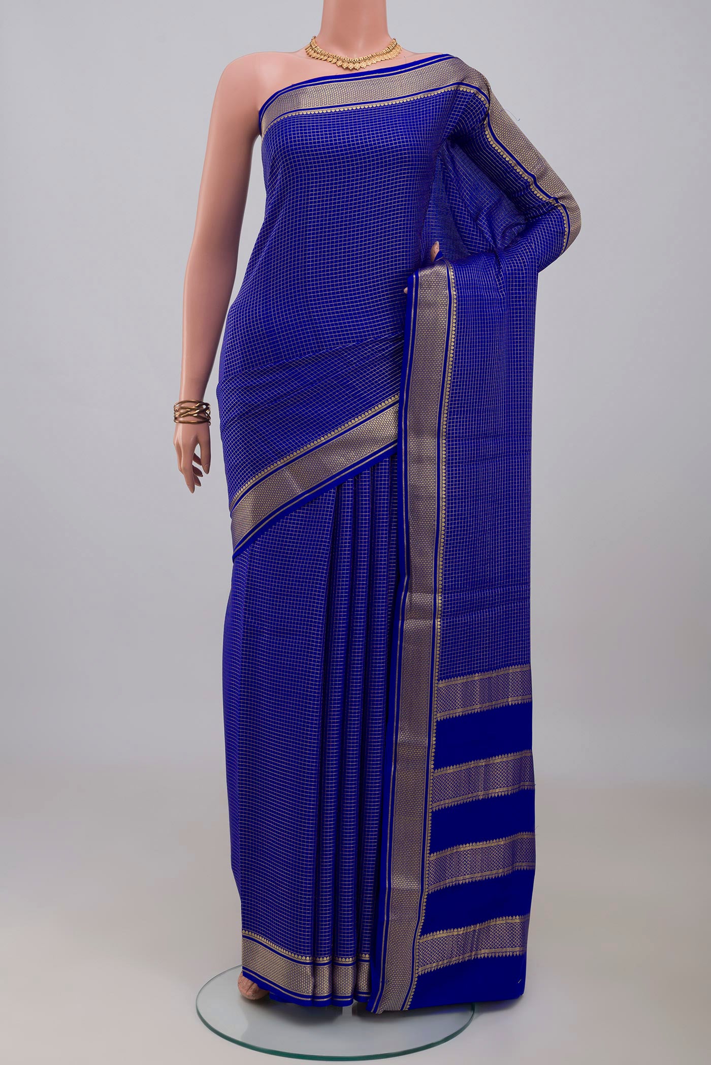 Royal Blue Mysore Crepe Saree with Checked design on the body and Zari Border.  displayed on a mannequin