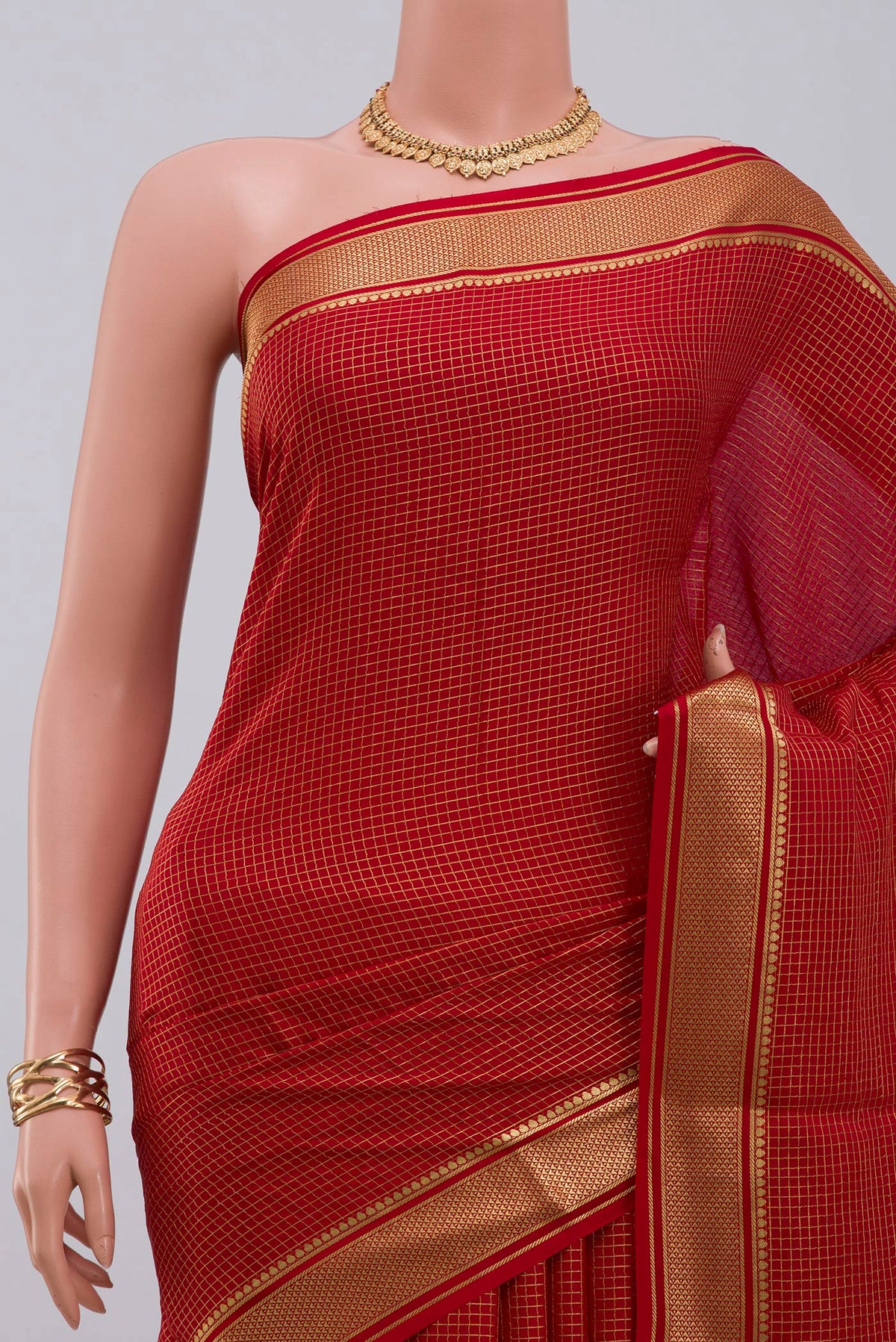 Border image of Red Crepe Saree with Checked design on the body and Zari Border. 
