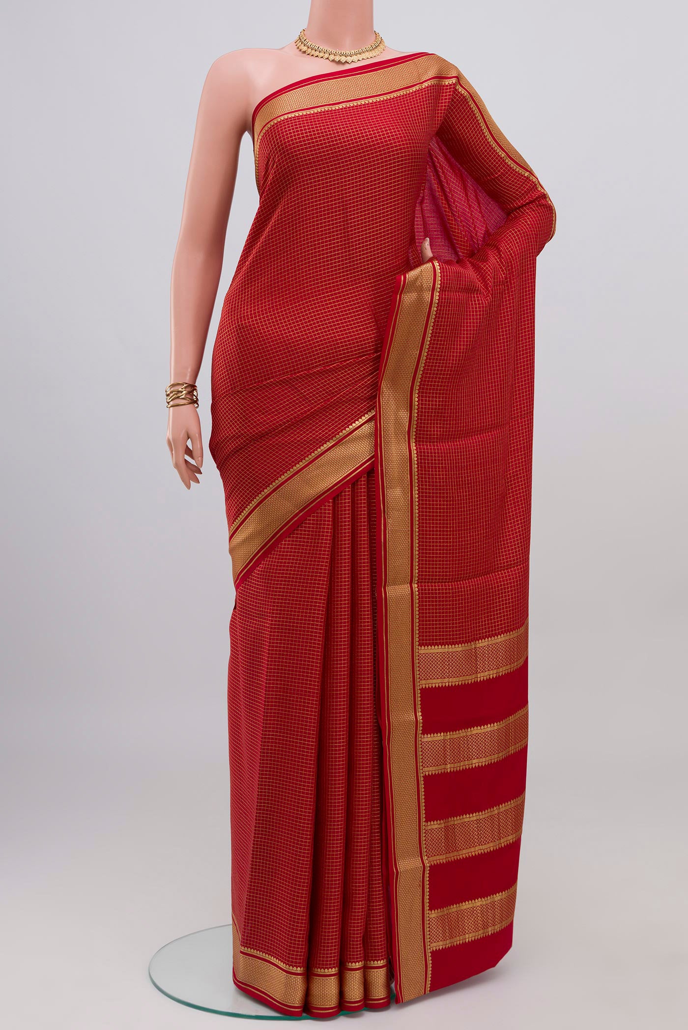 Red Mysore Crepe Saree with Checked design on the body and Zari Border.  displayed on a mannequin