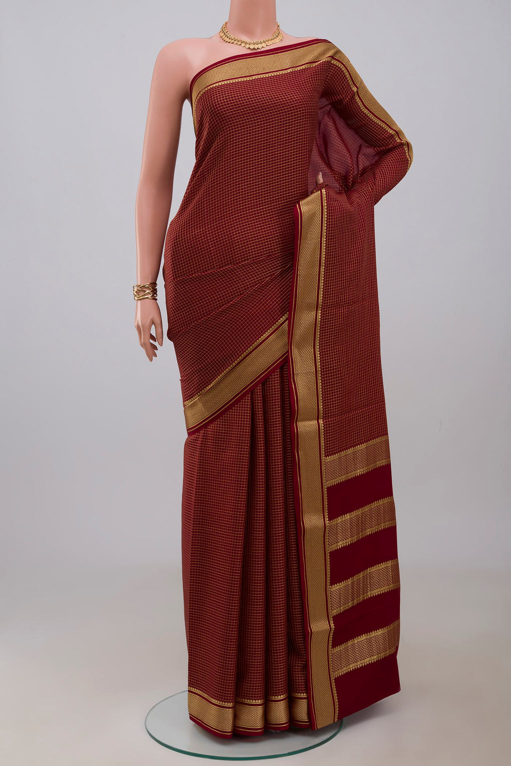 Maroon Mysore Crepe Saree with Checked design on the body and Zari Border.  displayed on a mannequin