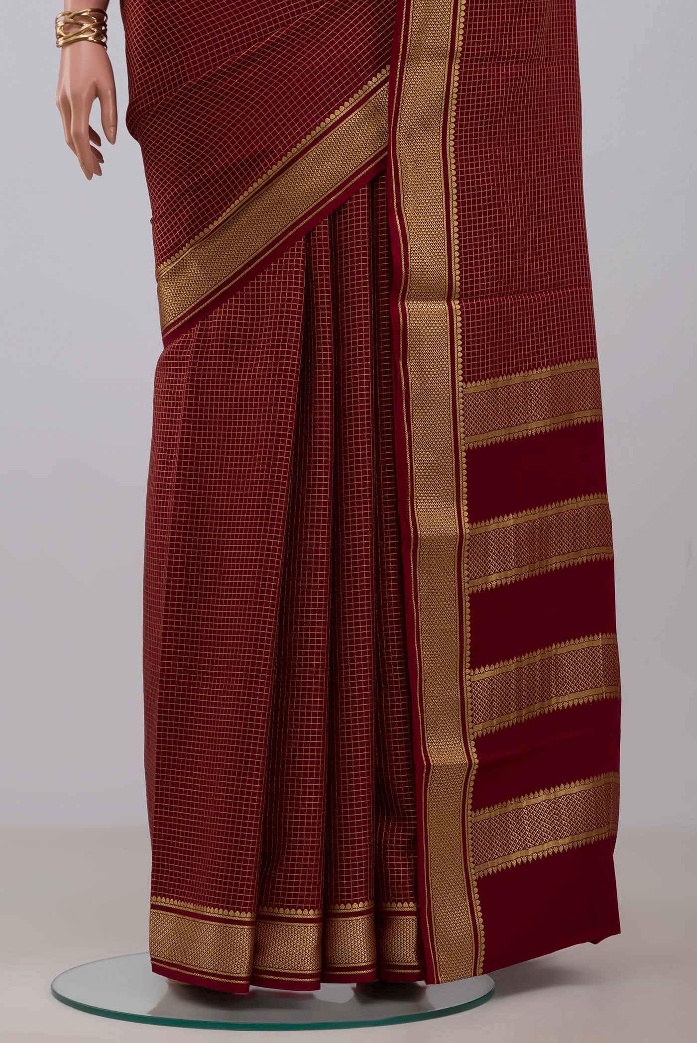 Pleats and pallu of Maroon Mysore Crepe Saree with Checked design on the body and Zari Border. 
