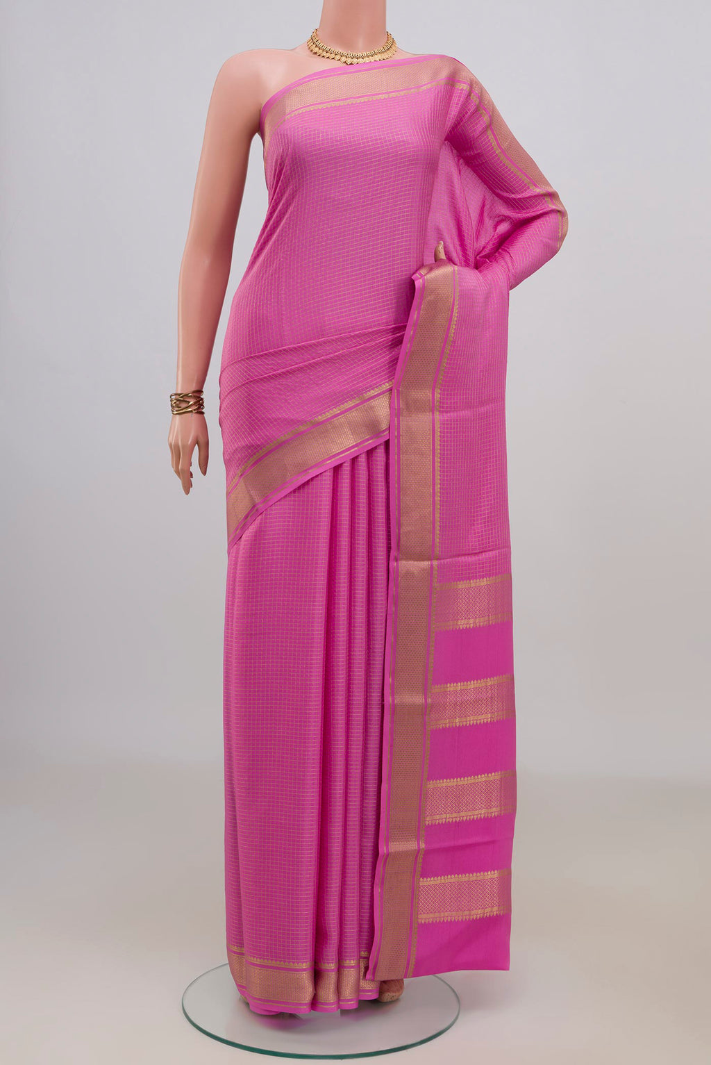 Pink Crepe Saree with Checked design on the body and Zari Border.  displayed on a mannequin