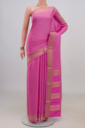 Pink Crepe Saree with Checked design on the body and Zari Border.  displayed on a mannequin