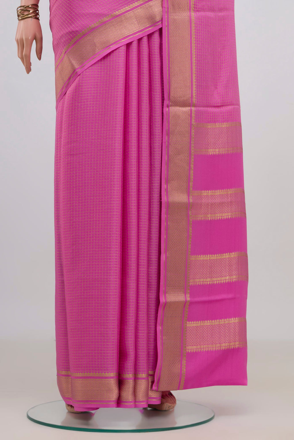 Pleats and pallu of Pink Crepe Saree with Checked design on the body and Zari Border. 