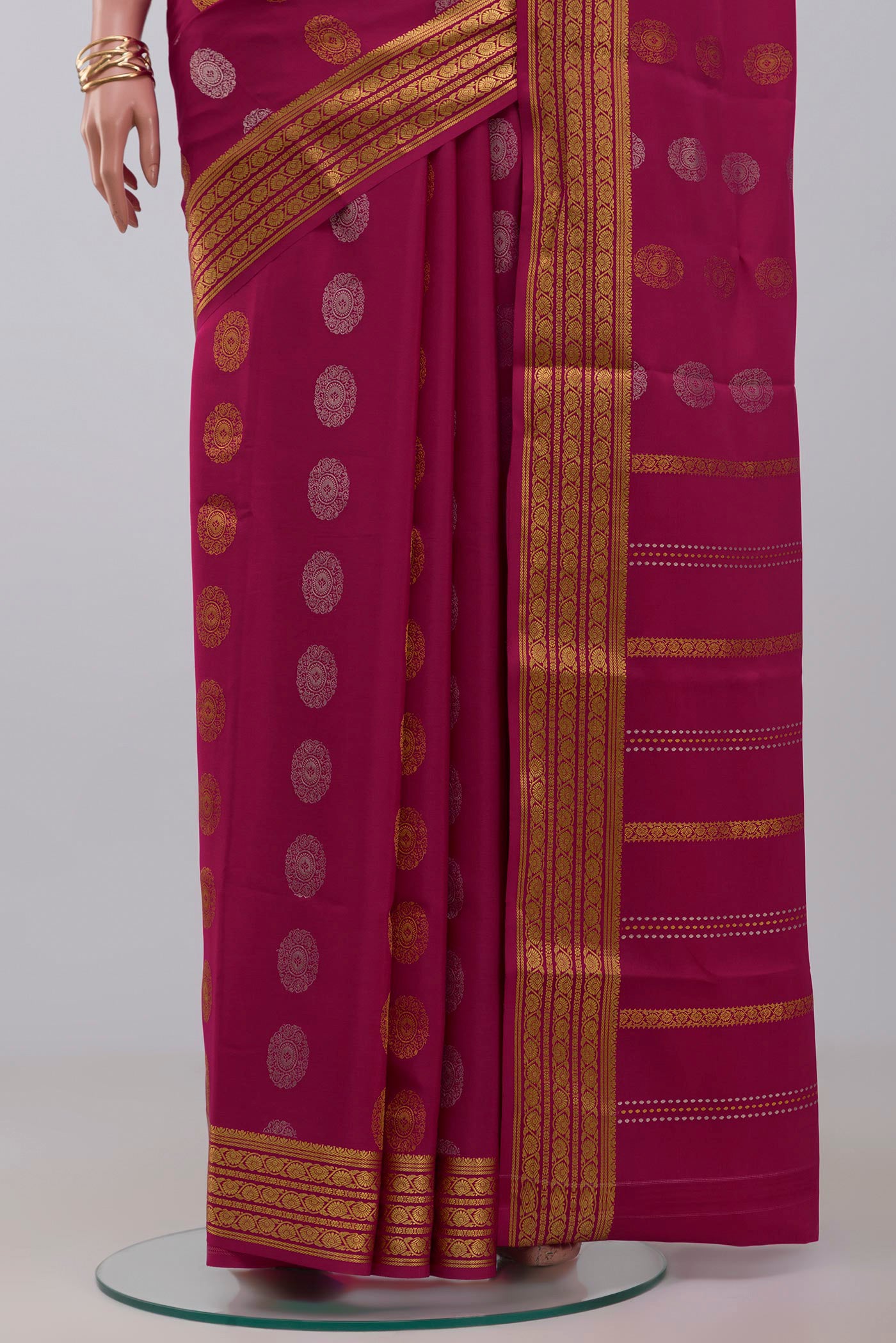 Pleats and pallu of Pink Crepe Saree with Zari Butta on the body and Zari Border. 