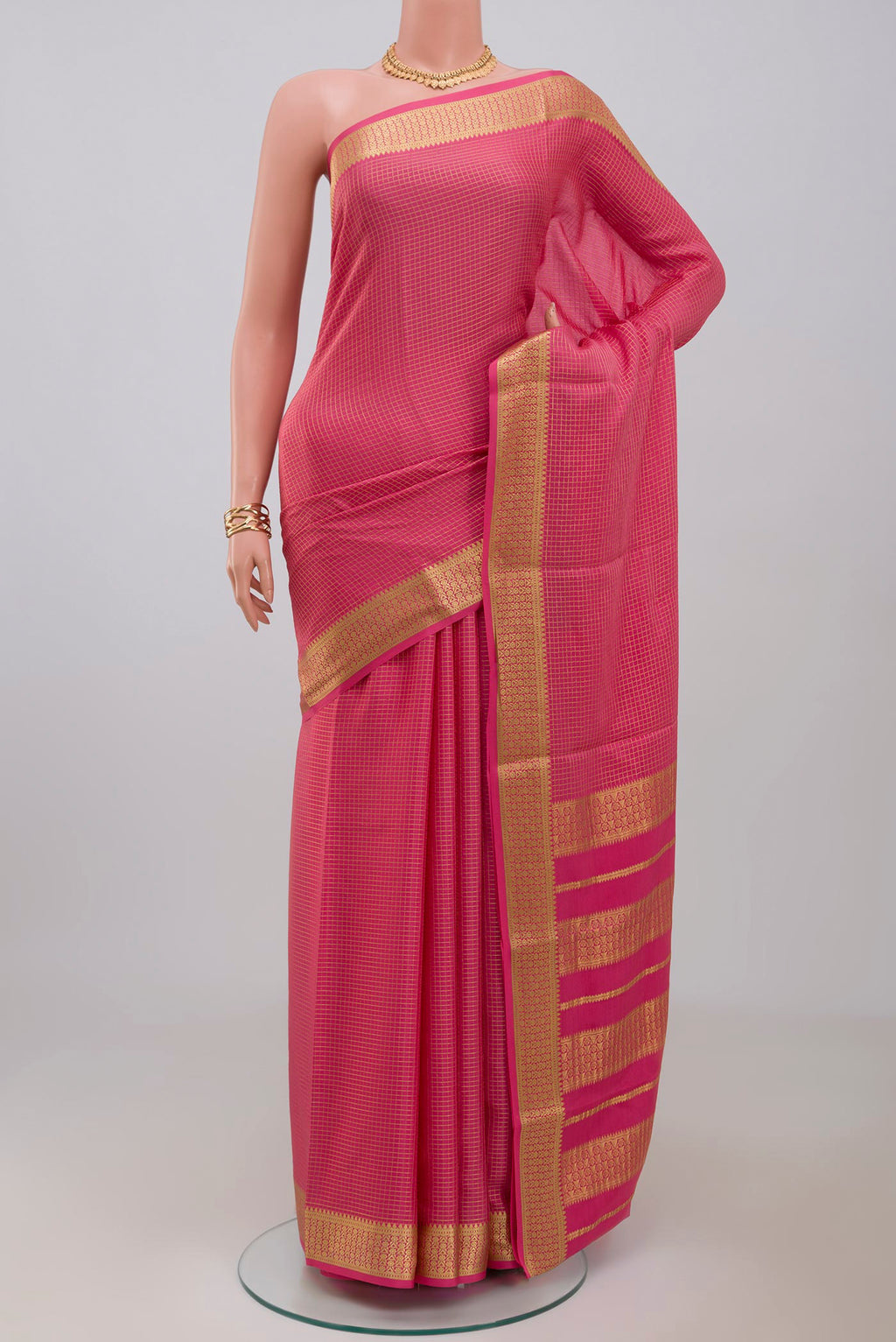 Pink Crepe Saree with Checked design on the body and Zari Border.  displayed on a mannequin
