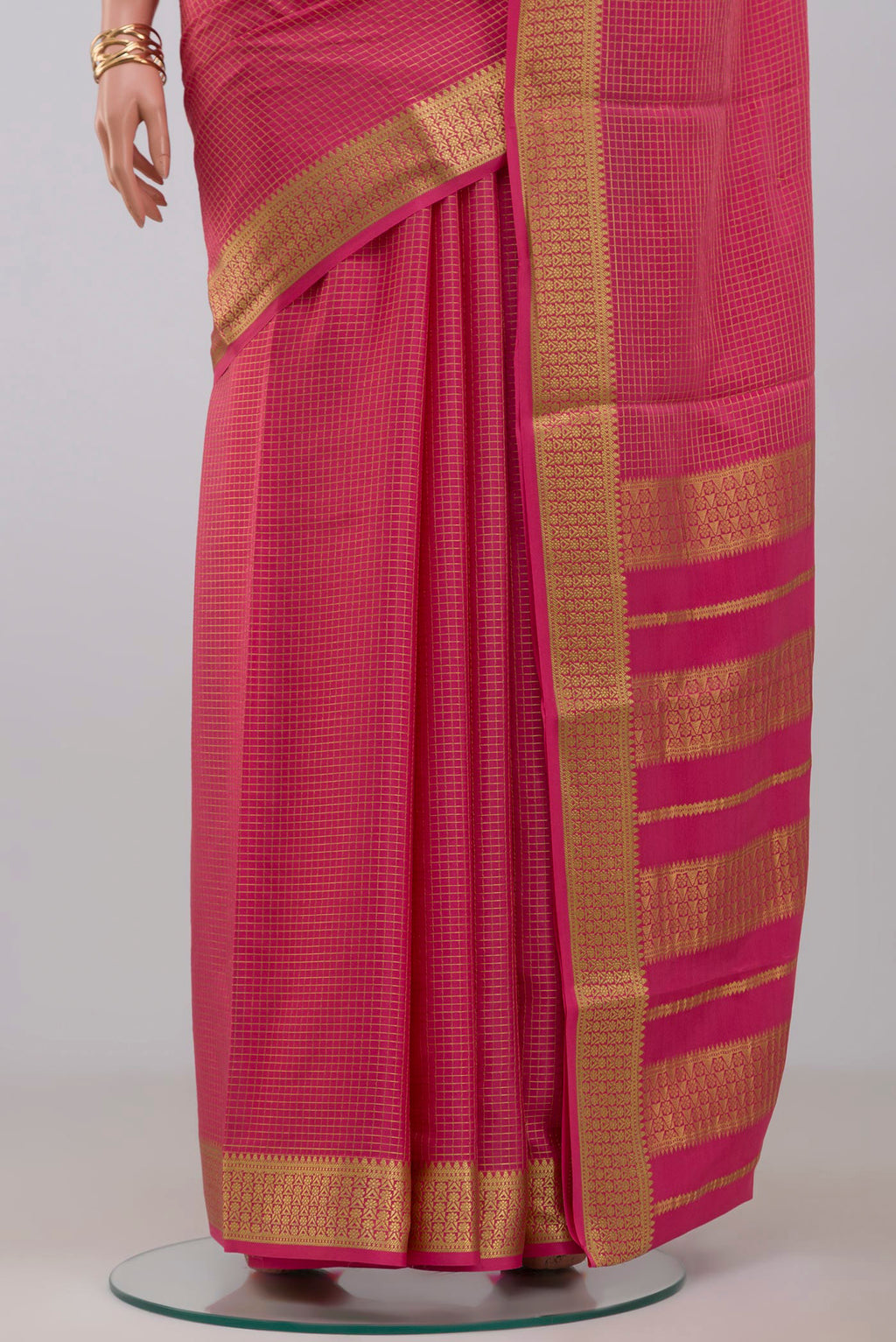 Pleats and pallu of Pink Crepe Saree with Checked design on the body and Zari Border. 