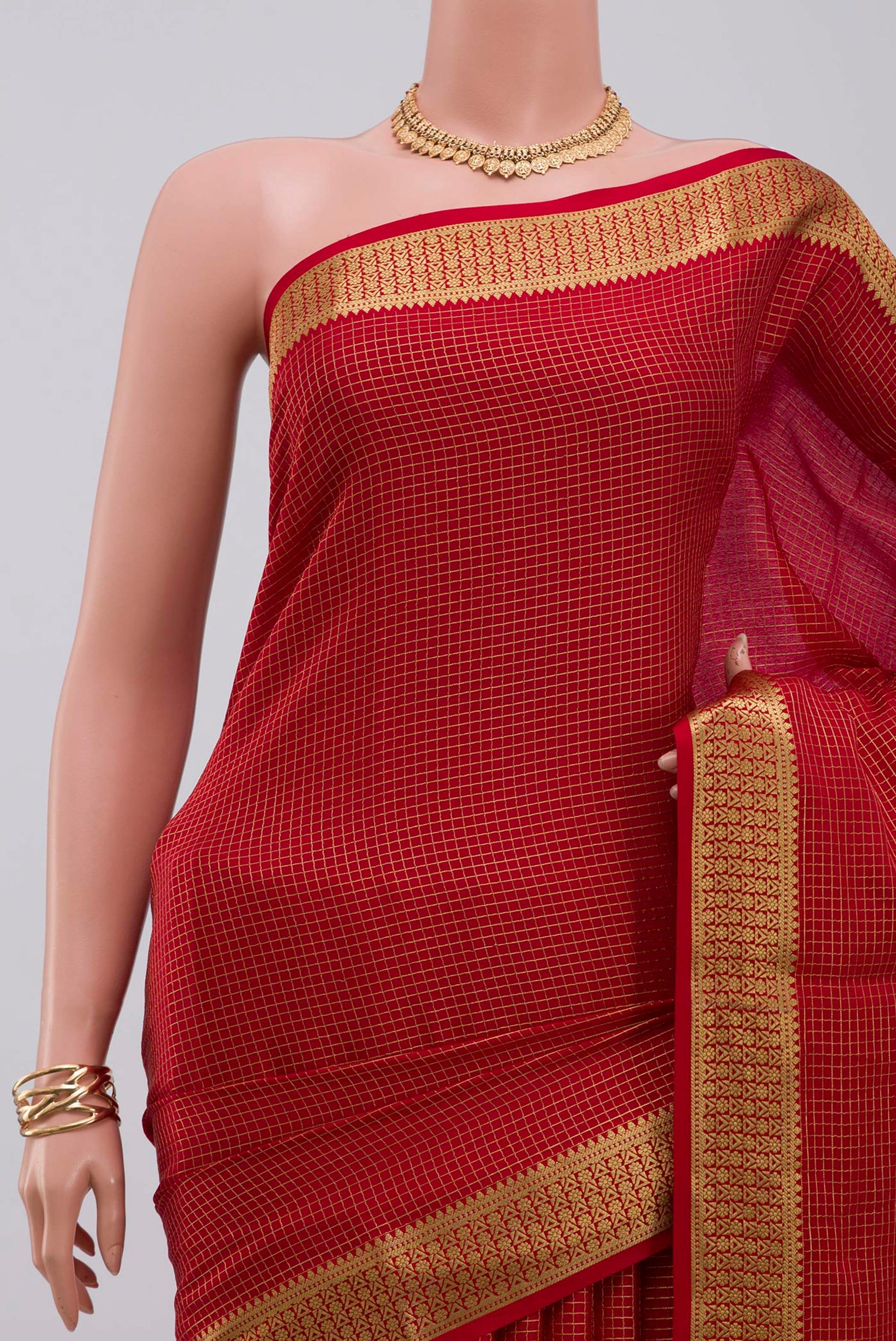 Border image of Red Crepe Saree with Checked design on the body and Zari Border. 